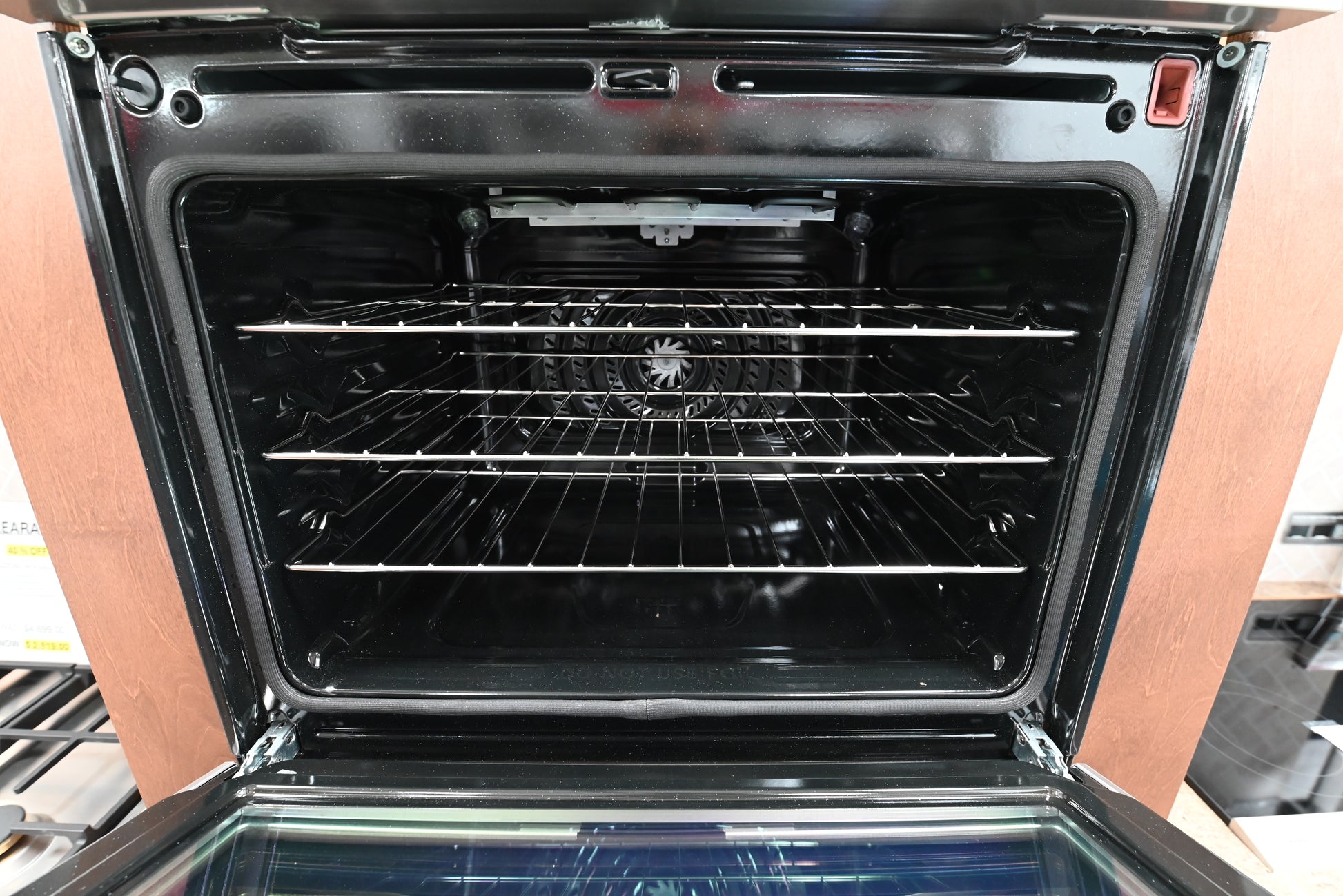 Luxury double wall oven doors open showing beautiful porcelain interiors and glide racks