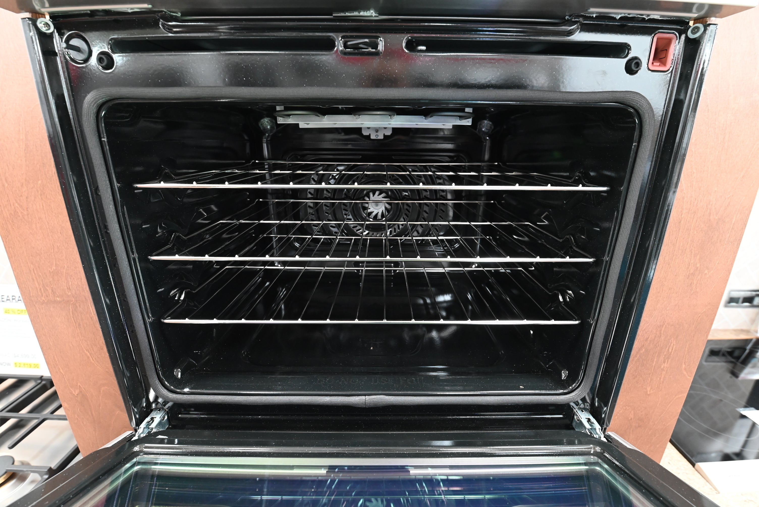 Luxury double wall oven doors open showing beautiful porcelain interiors and glide racks