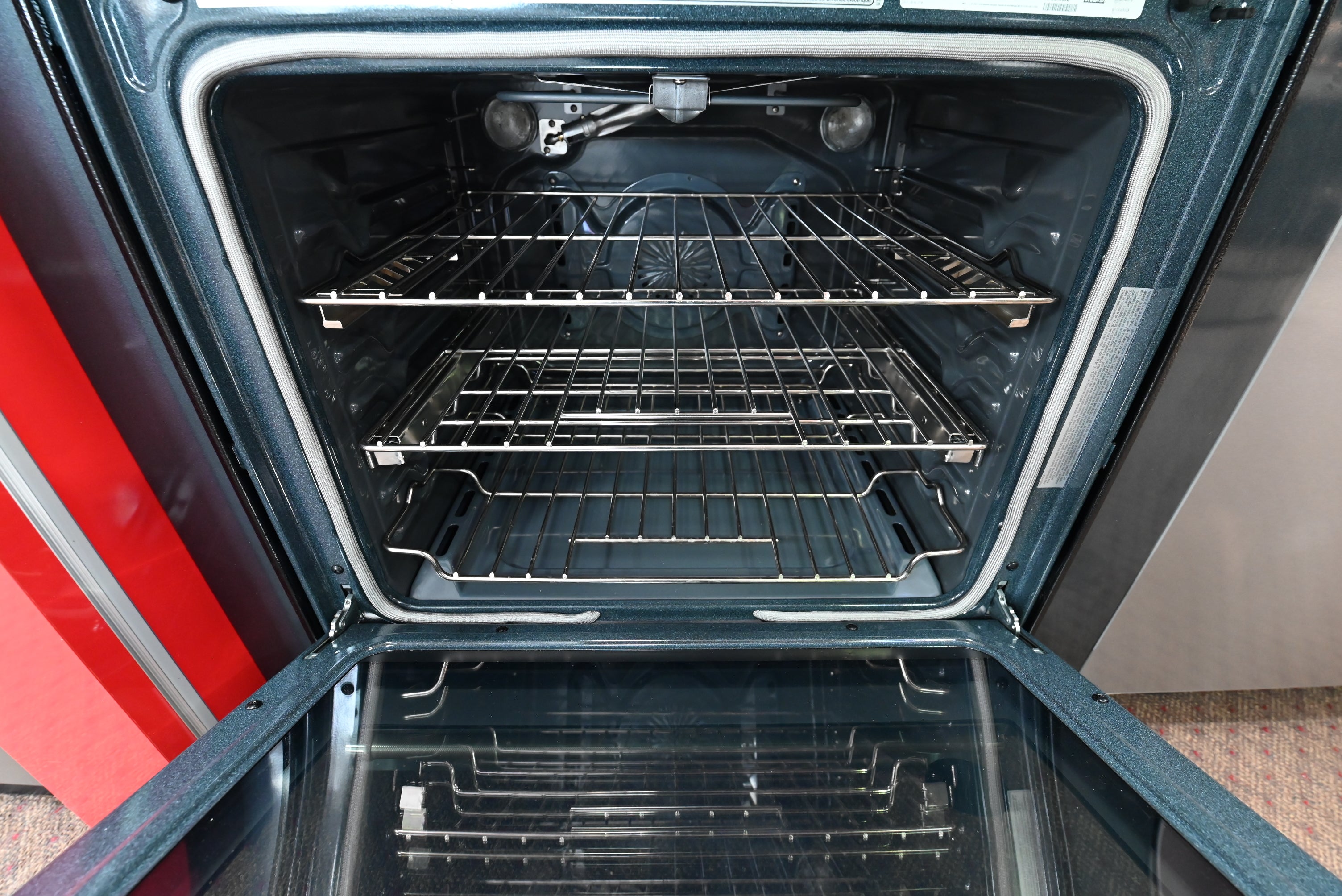KitchenAid 30 inch range open door showing blue porcelain interior and lower baking drawer open