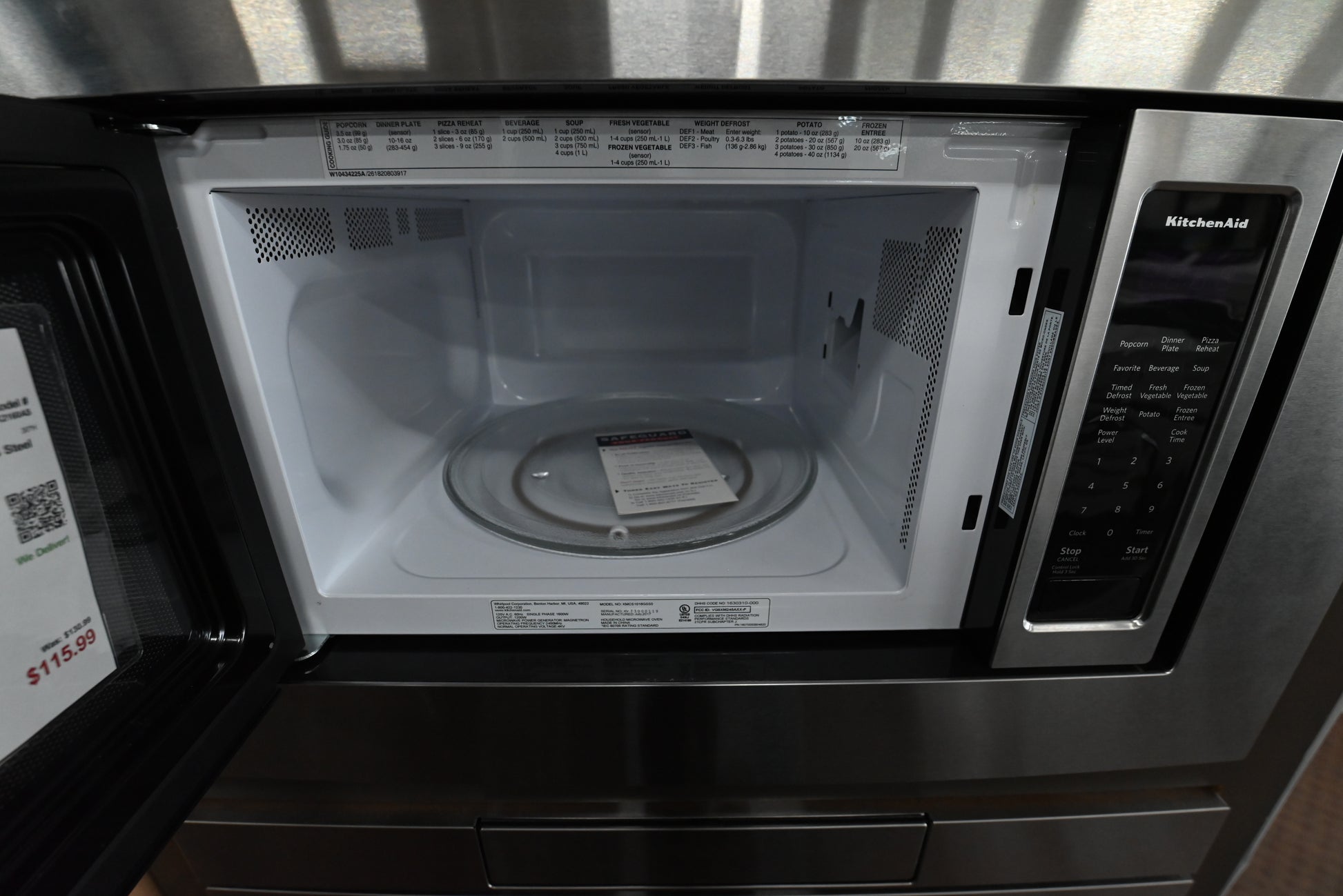Premium 1200 watt KitchenAid microwave door open showing recessed glass turntable interior