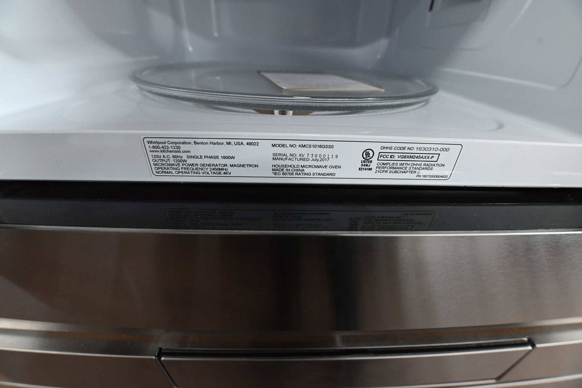 KitchenAid 1.6 cubic feet microwave integrated into cabinetry with a matching stainless steel trim kit