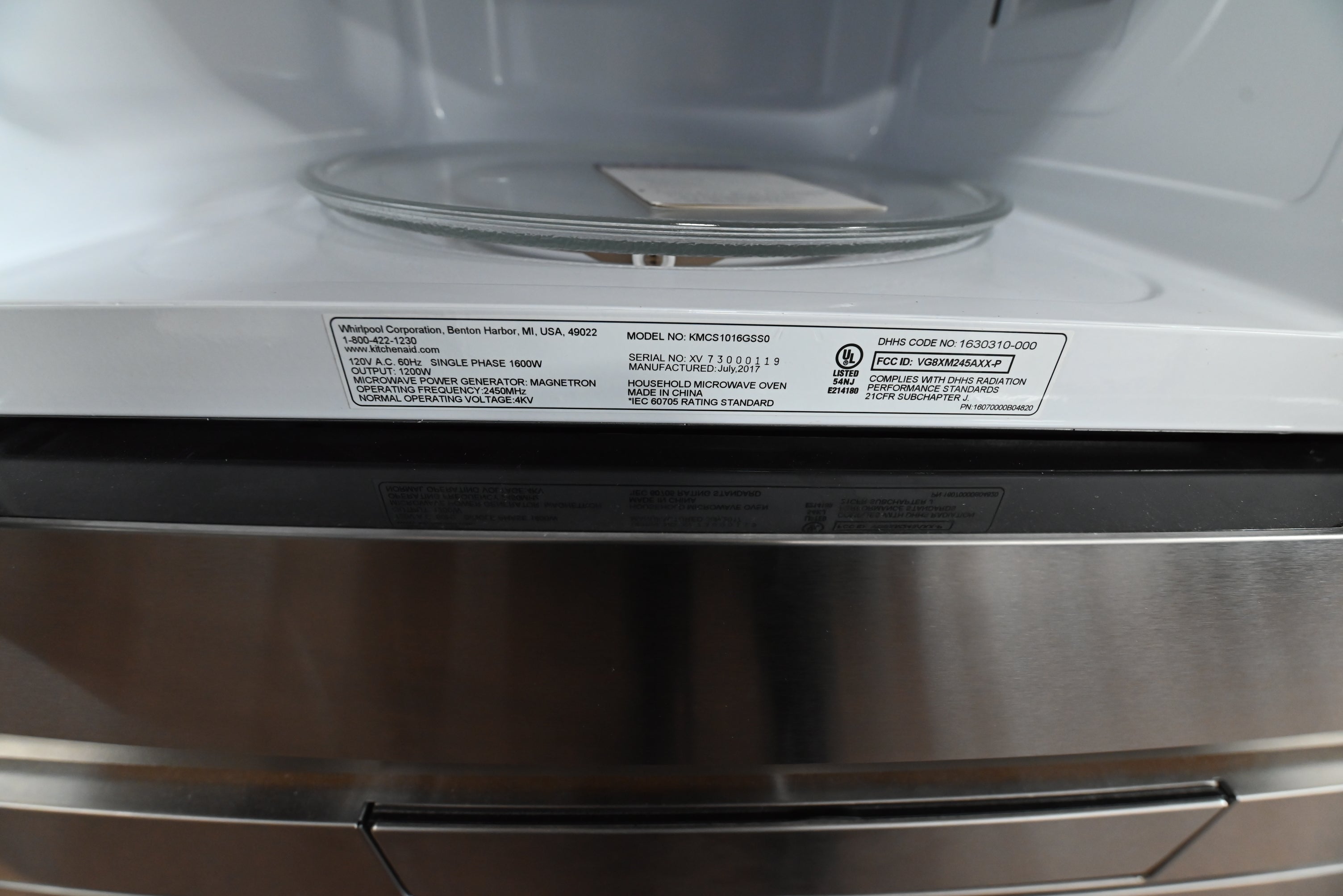 KitchenAid 1.6 cubic feet microwave integrated into cabinetry with a matching stainless steel trim kit