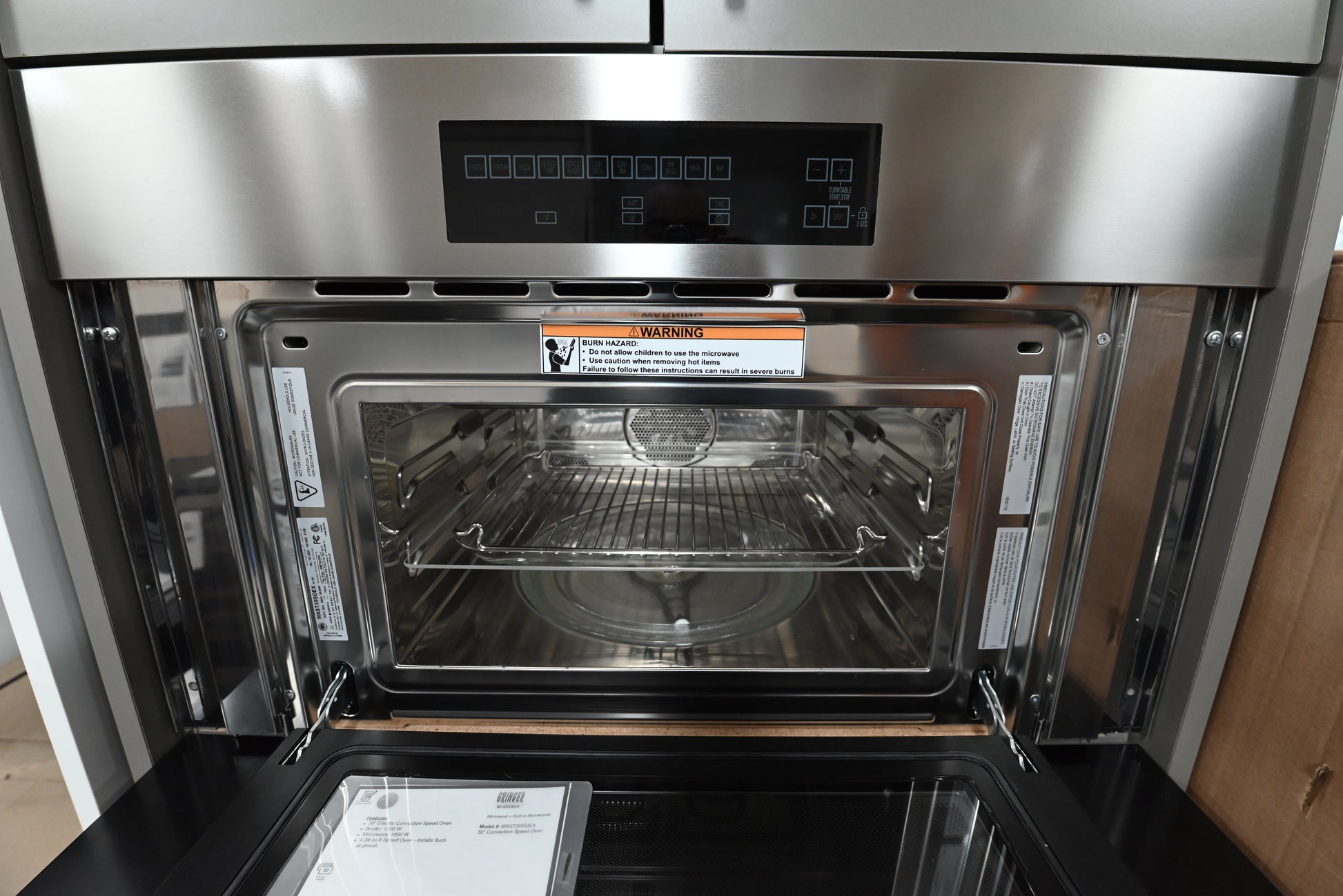 Luxury 30 inch built in speed oven showing pro style stainless handle bar and top edge touch controls