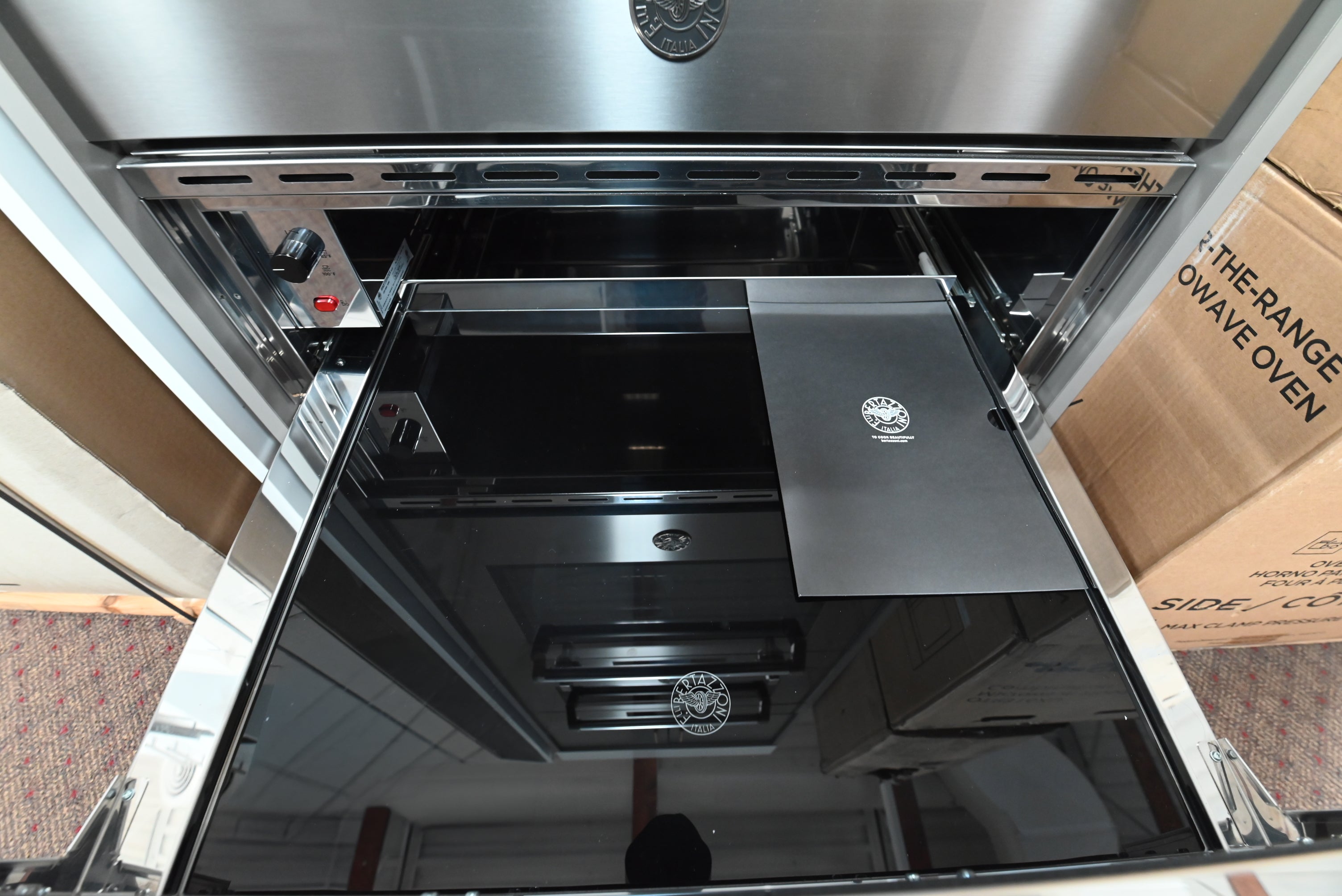 Luxury 30 inch Bertazzoni warming drawer extended showing open sided construction and glass bottom