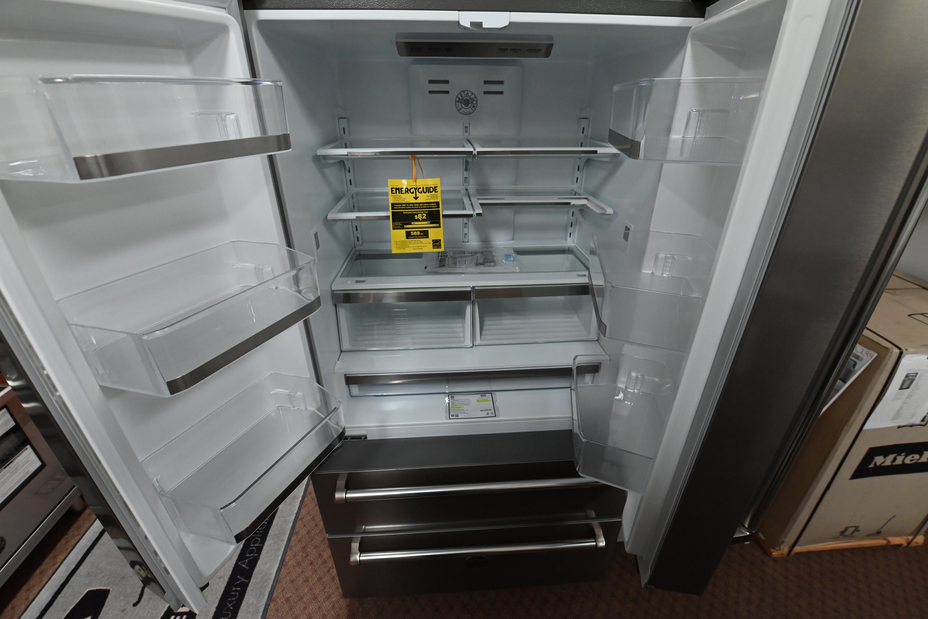 Luxury 36 inch counter depth refrigerator doors open showing white interior shelves crispers and LED lighting