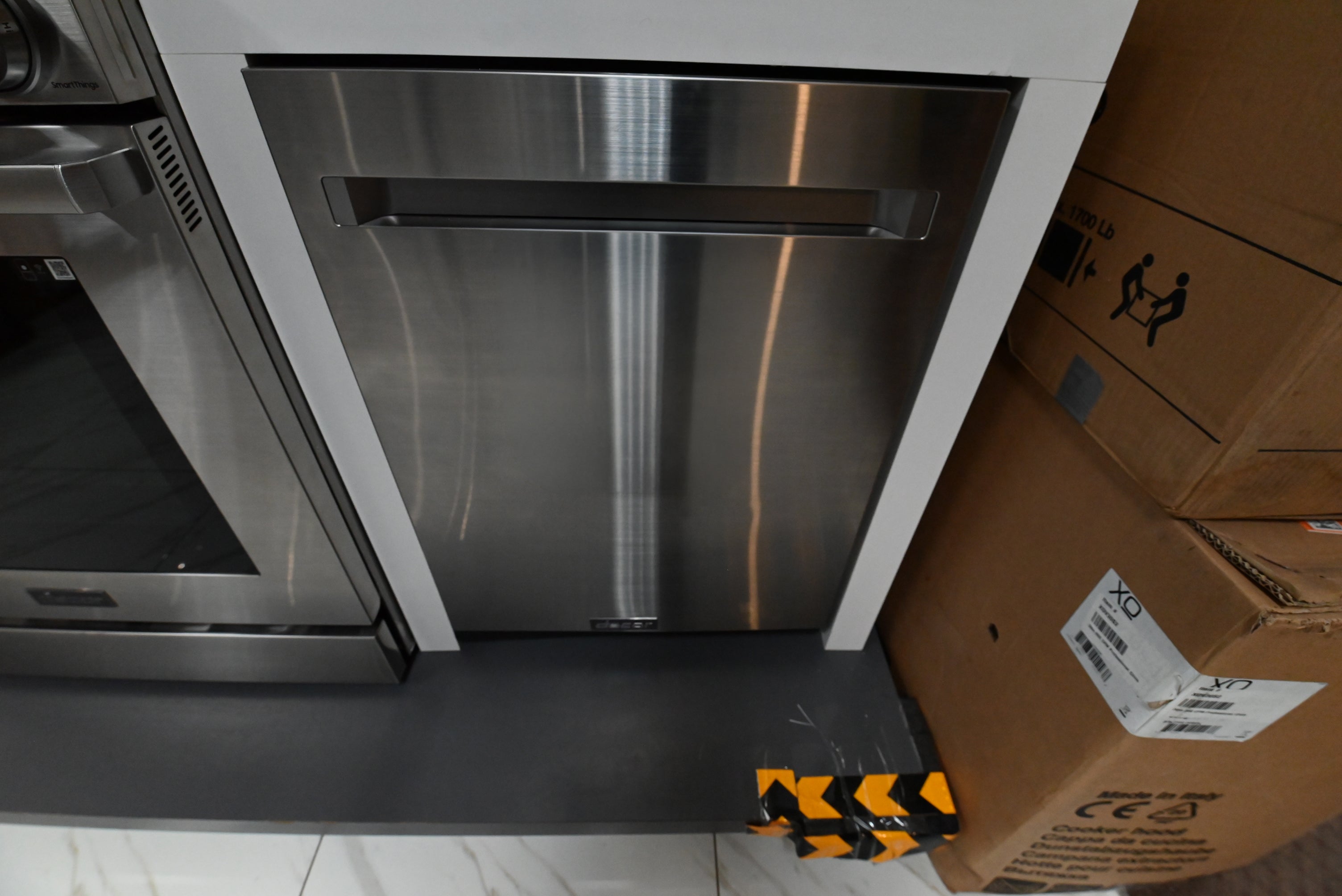 Dacor DDW24G9000APDA 24 inch integrated dishwasher front view with silver stainless steel panel kit