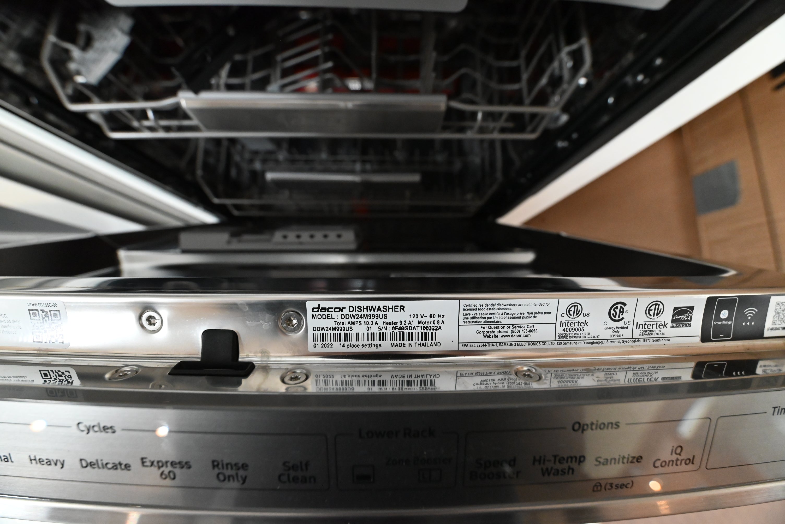 Dacor 24 inch dishwasher open showing stainless steel tub and 3rd rack cutlery tray