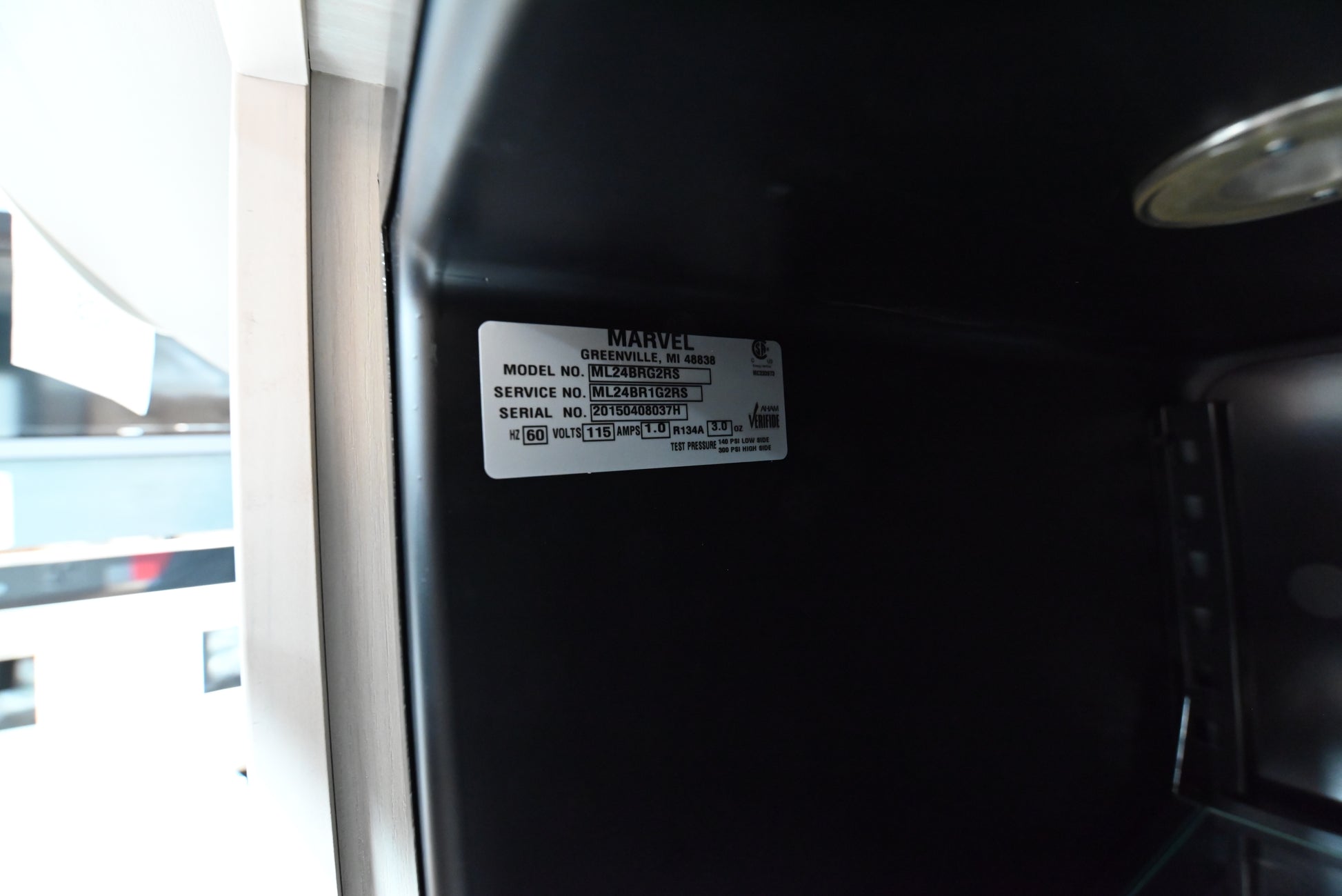 Marvel 24 inch high capacity beverage center refrigerator installed flush inside a custom home bar island