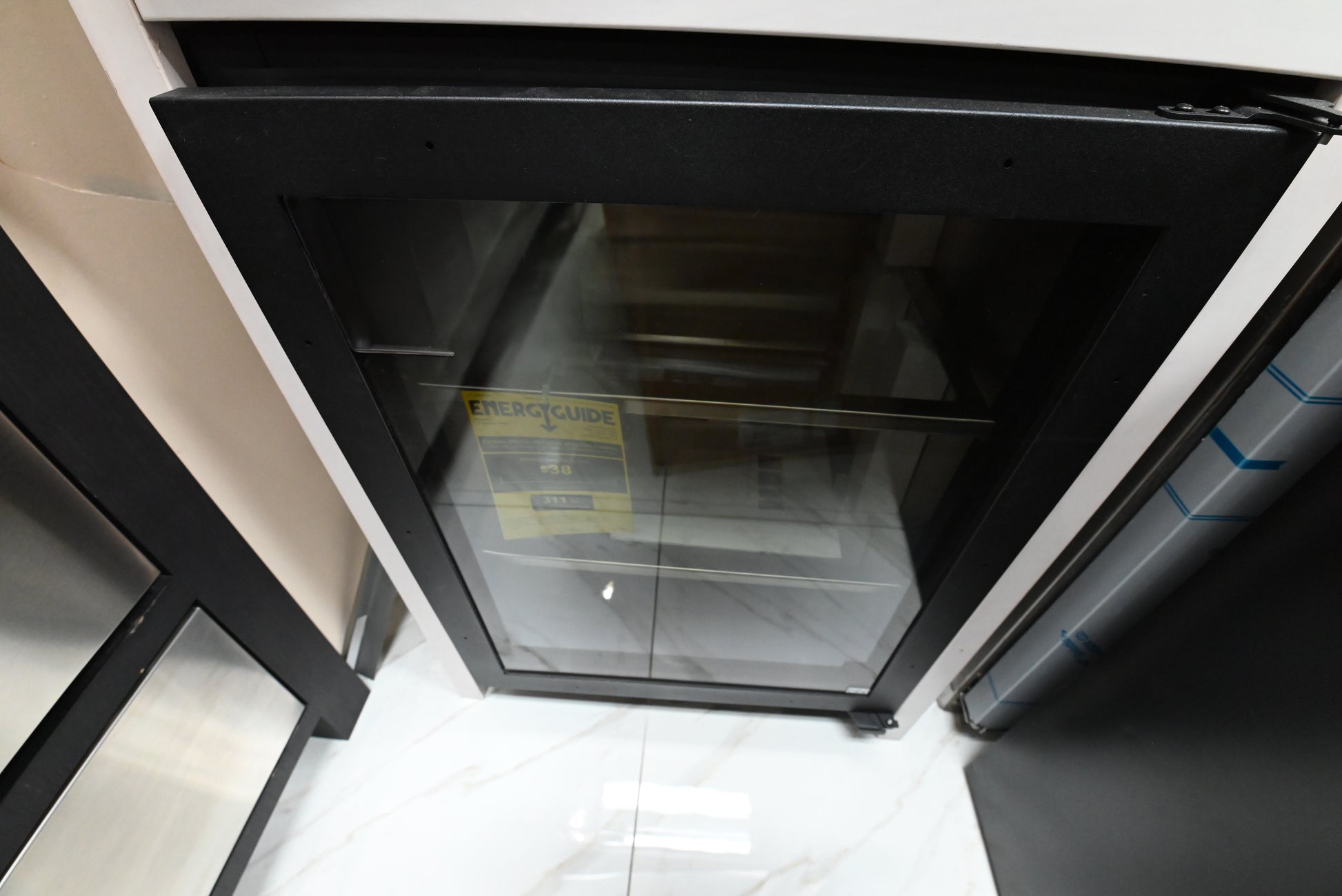 Luxury outdoor rated under counter glass door refrigerator open showing 300 series stainless steel interior and TruLumina LED lighting
