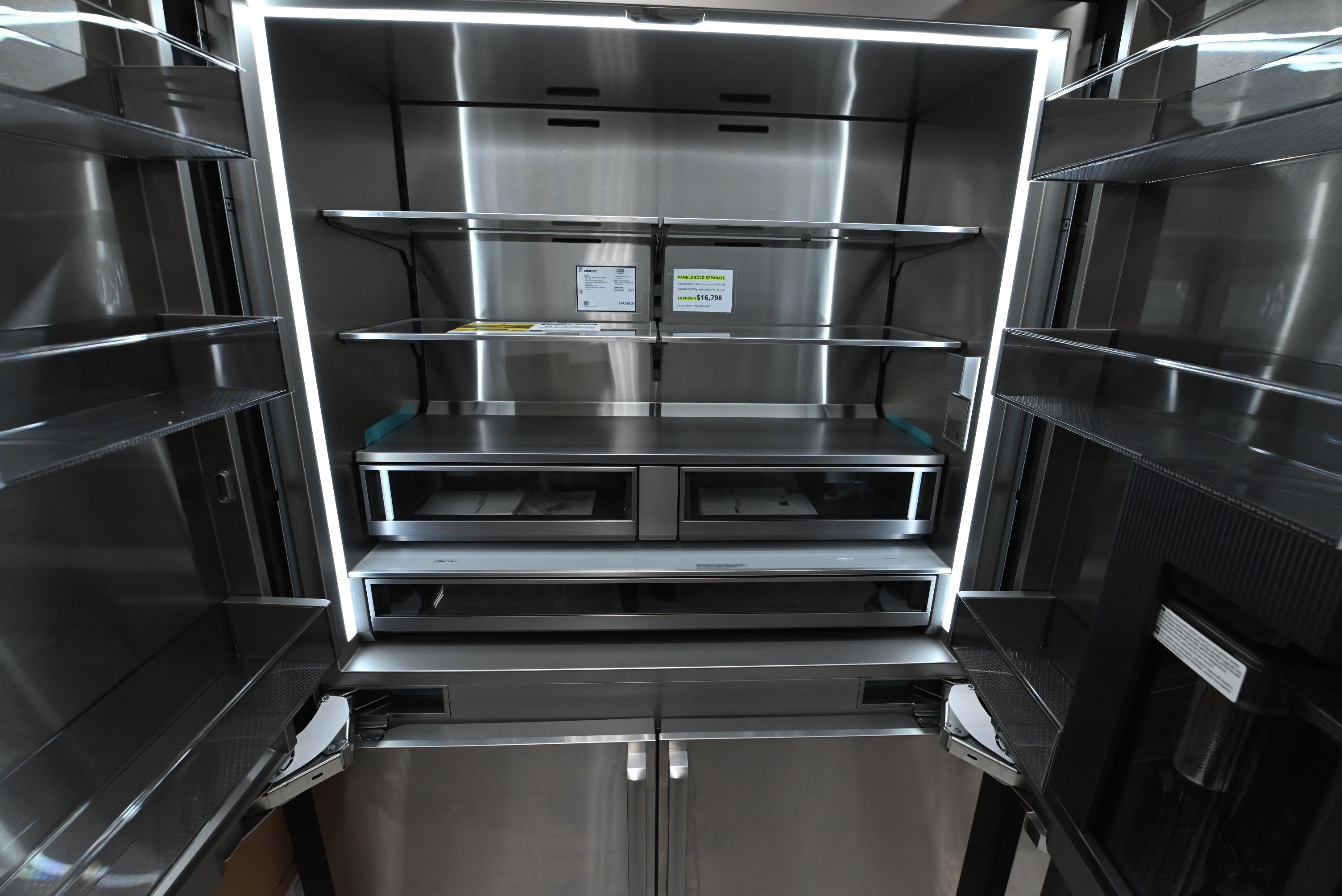 Dacor 48 integrated refrigerator open showing multi zone triple cooling glass shelves