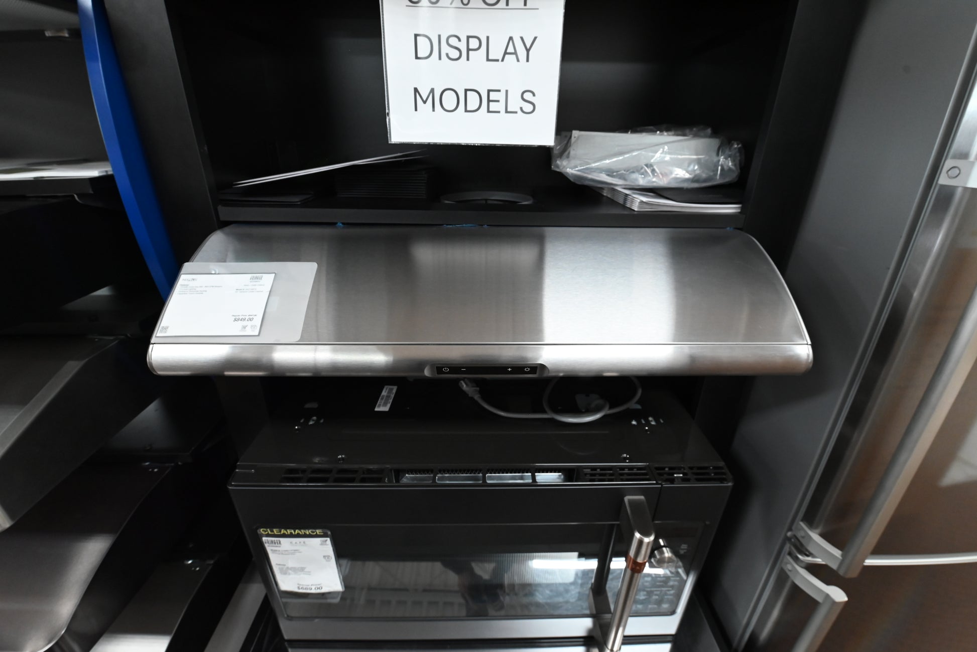 Under cabinet range hood looking up showing Zephyr filterless self cleaning setup and LumiLight LED strips