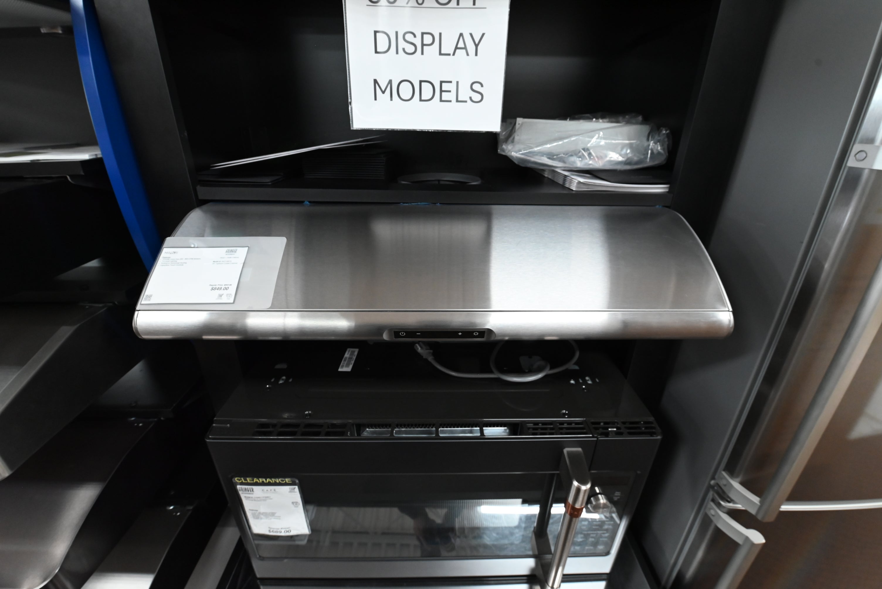 Under cabinet range hood looking up showing Zephyr filterless self cleaning setup and LumiLight LED strips