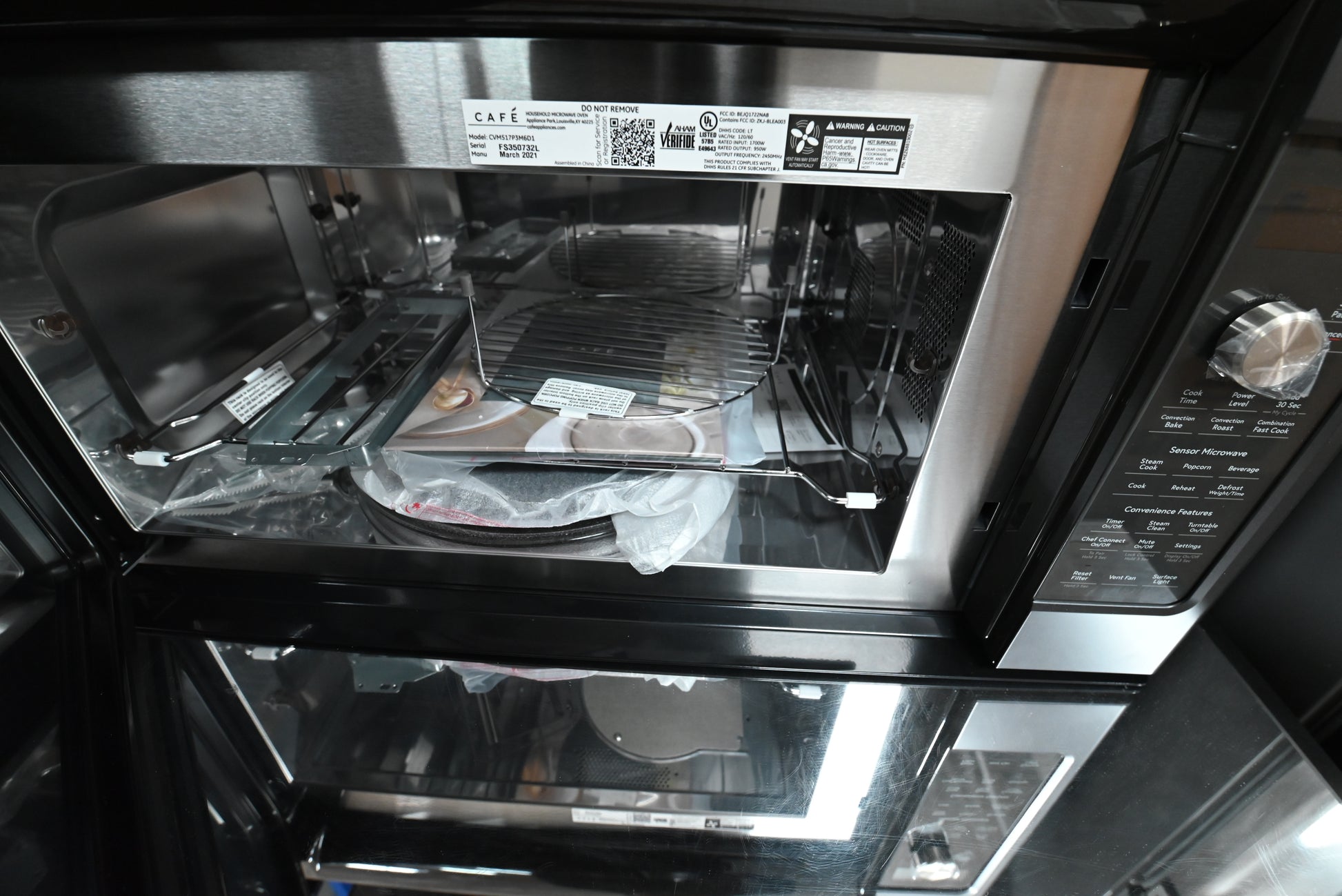 Luxury 30 inch over the range microwave with 300 CFM ventilation and brushed stainless handle by Cafe