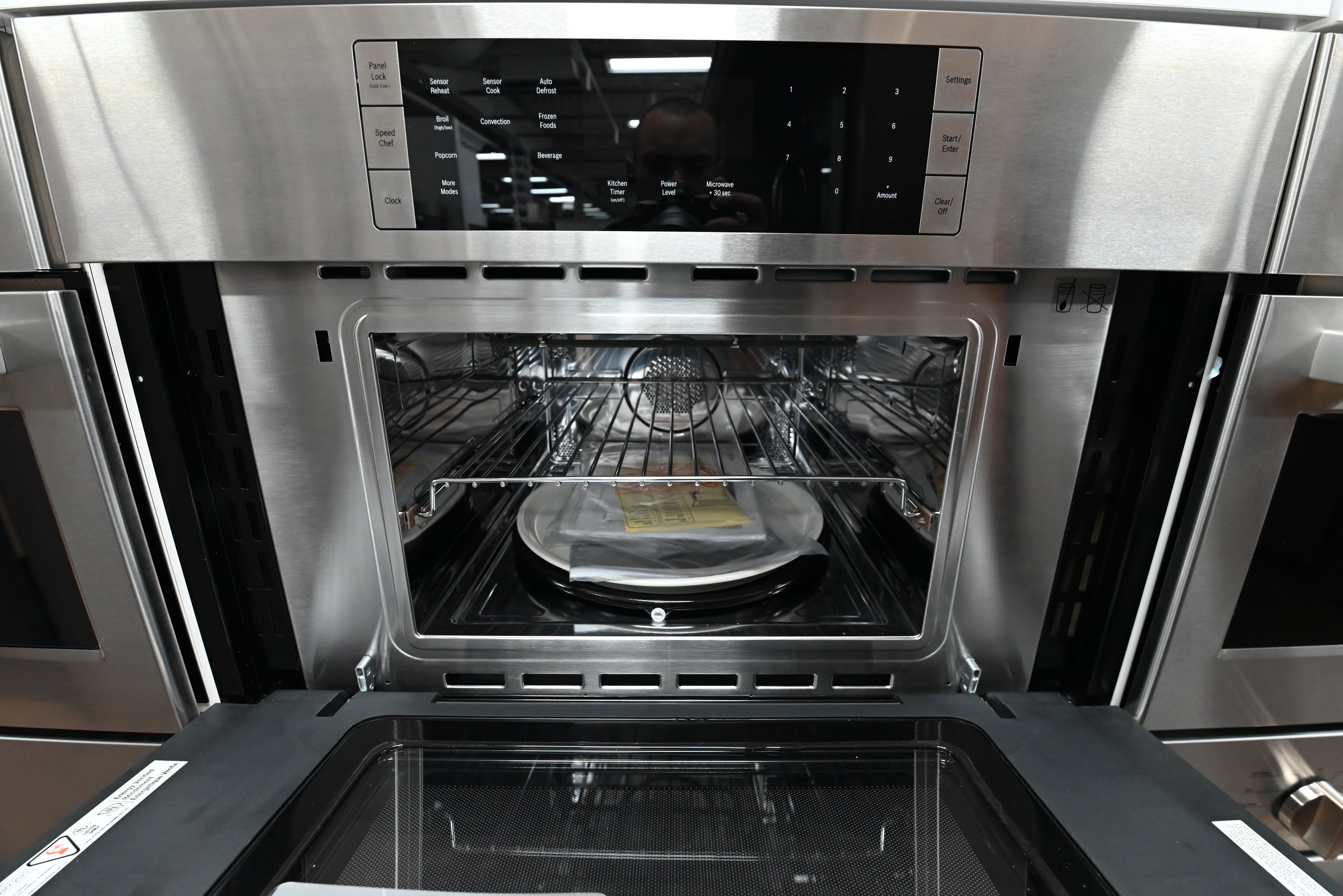Luxury 30 inch integrated 2 in 1 speed oven open showing stainless steel interior and wire grids