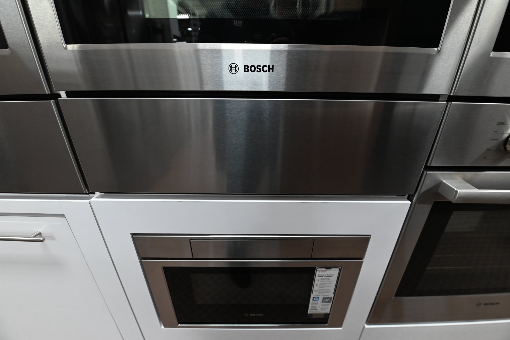 Luxury 30 inch integrated warming drawer open showing low side access walls and telescopic rails