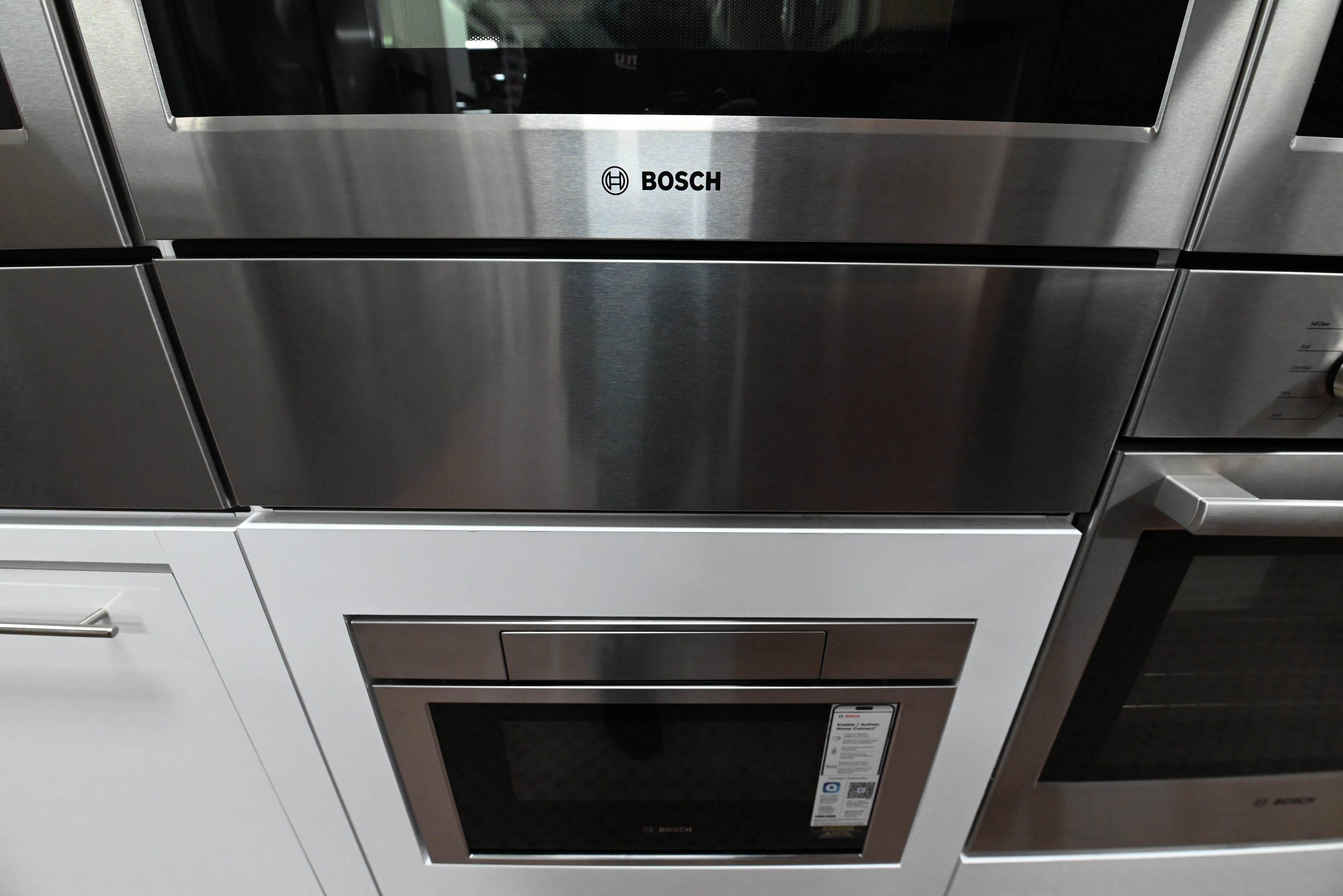 Luxury 30 inch integrated warming drawer open showing low side access walls and telescopic rails