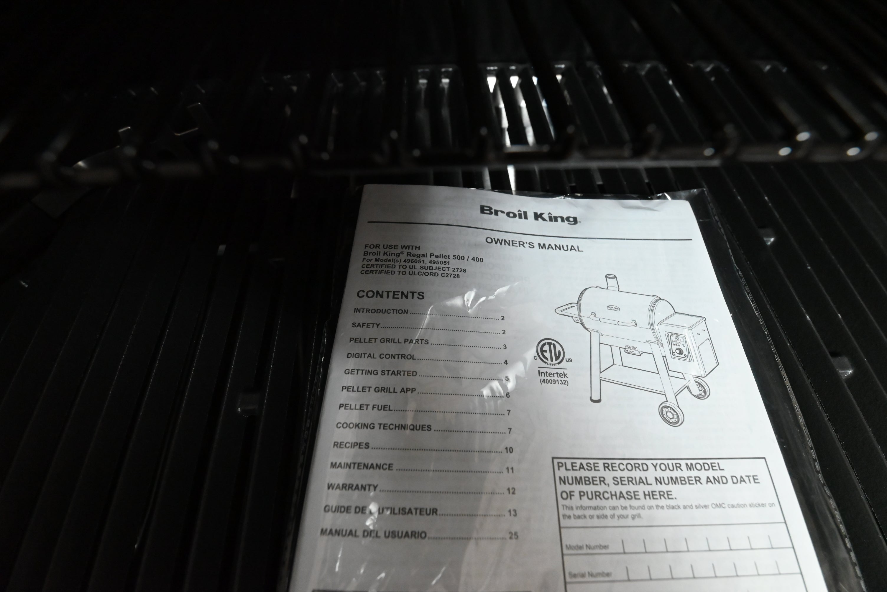 Broil King pellet 500 showing digital control board panel screen and 22 pound hopper