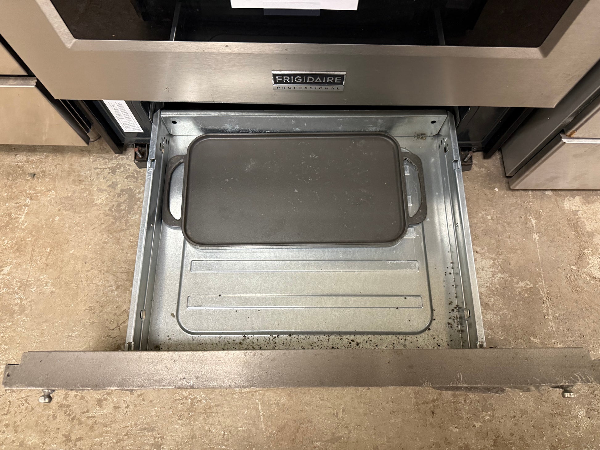 Open drawer with a grill pan inside, branded 'Broil King'.