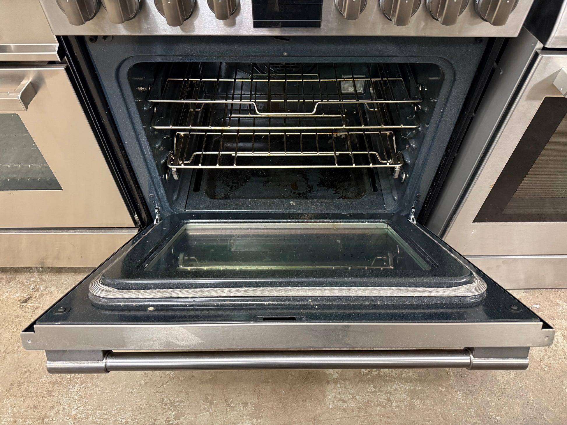 Stainless steel oven with open door in a kitchen setting