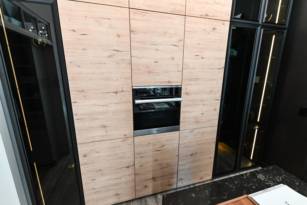 Nolte Küchen Modern Black Kitchen with Unique Accent Wall Cabinetry