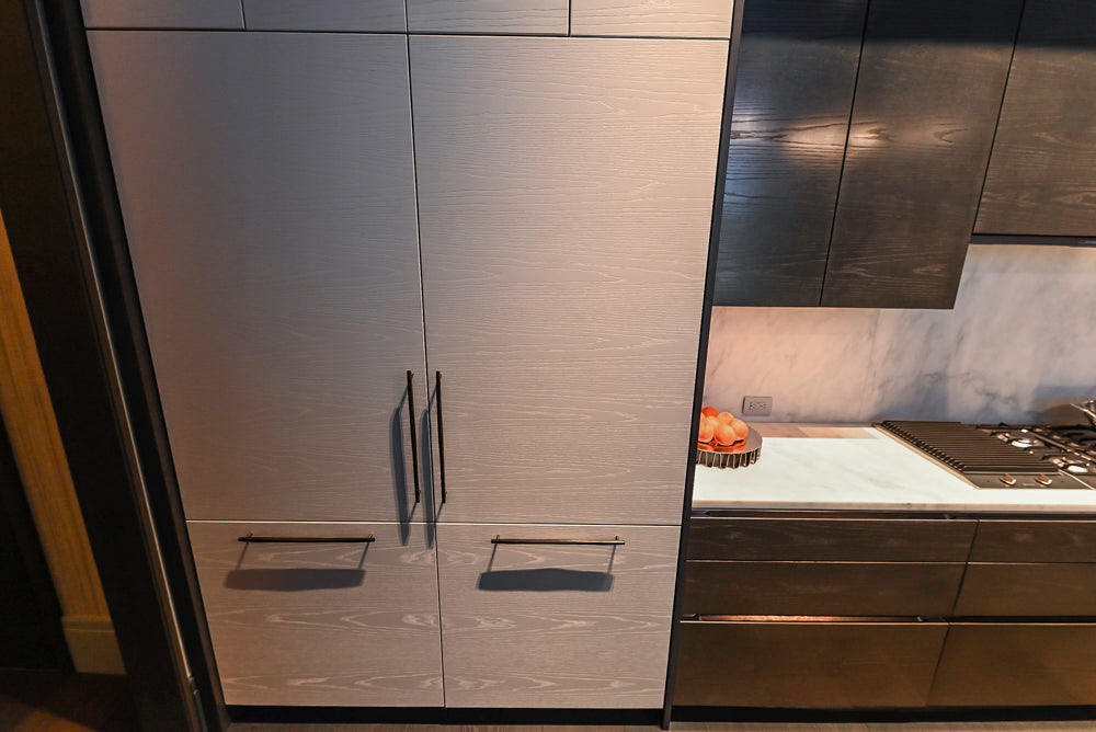 Modern White and Brown Wood Veneer Kitchen with Waterfall Island, Marble Countertops & Miele Appliances