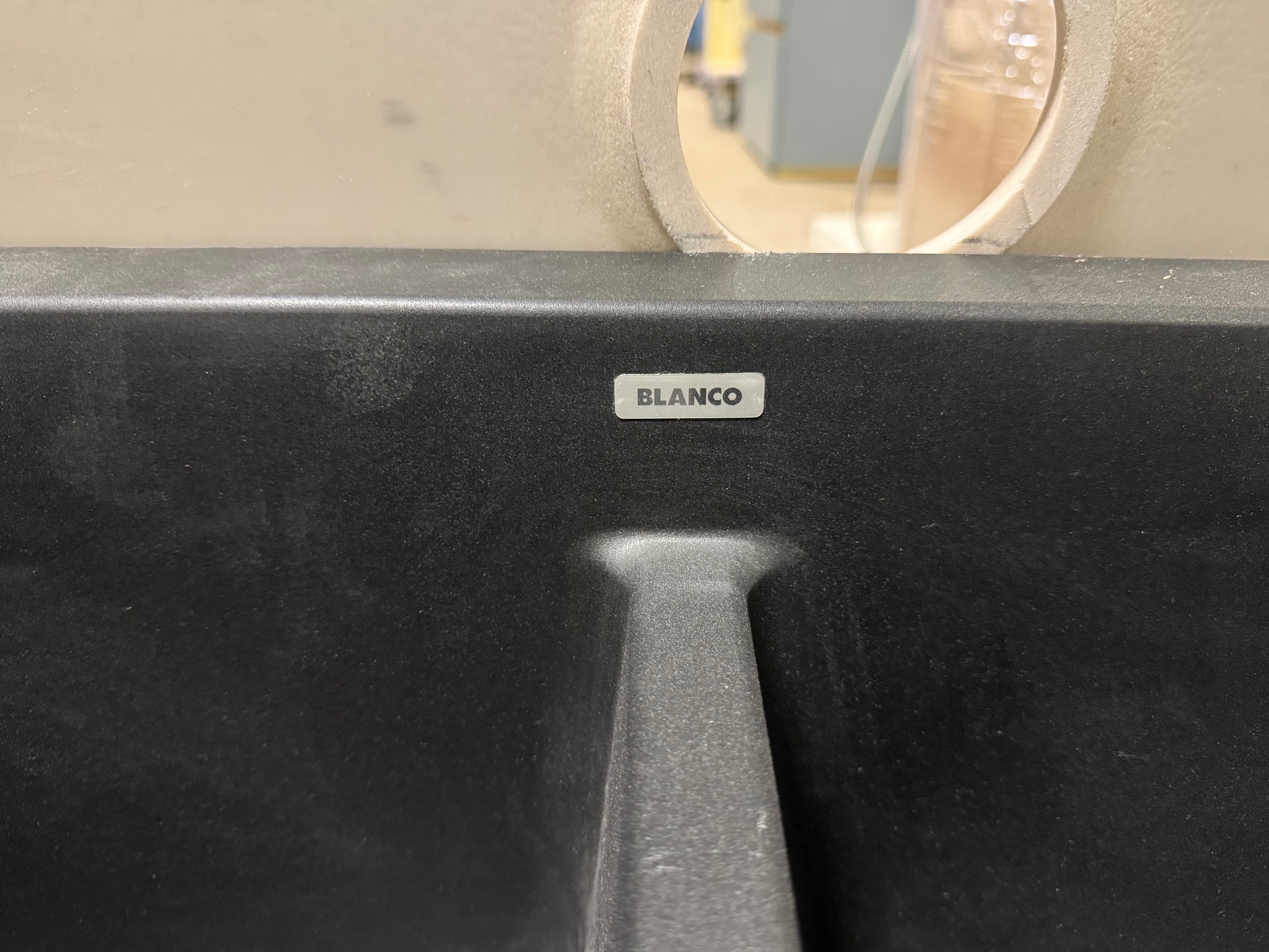 Black kitchen sink with BLANCO logo on a neutral background