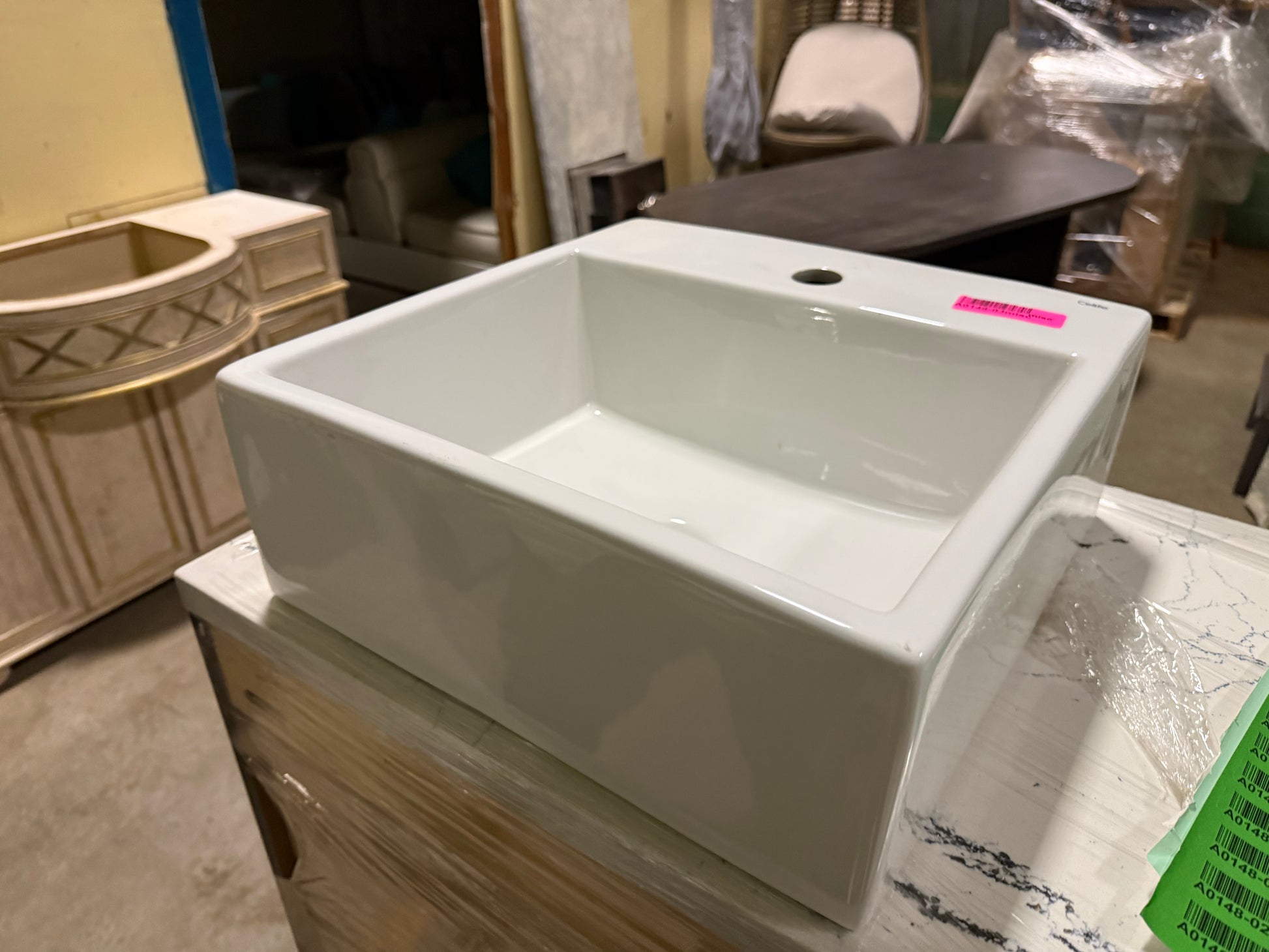 White ceramic sink on a wooden stand with a blurred background