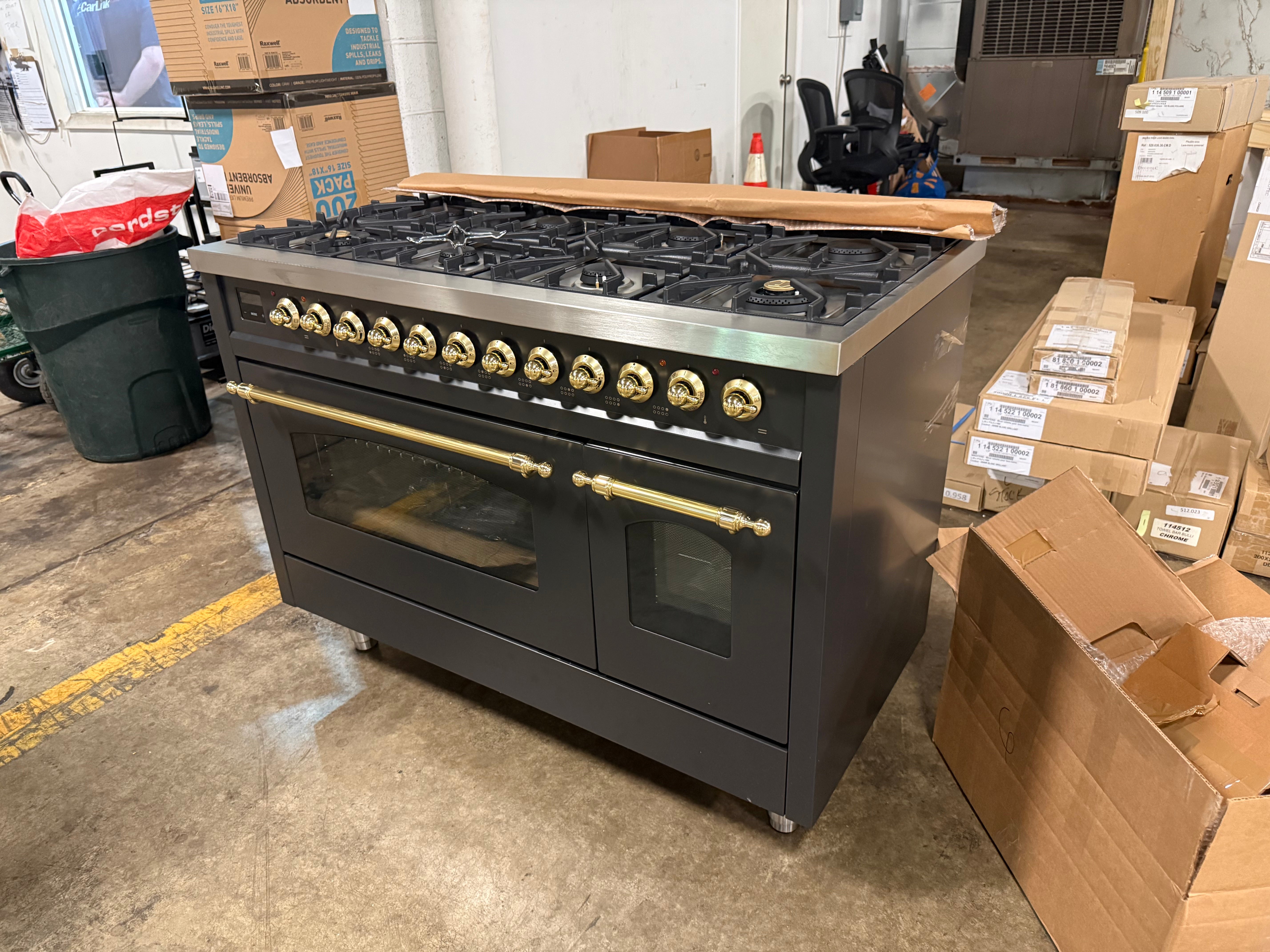 Showroom display 48 inch ILVE range displaying 8 black brass burners and continuous iron grates