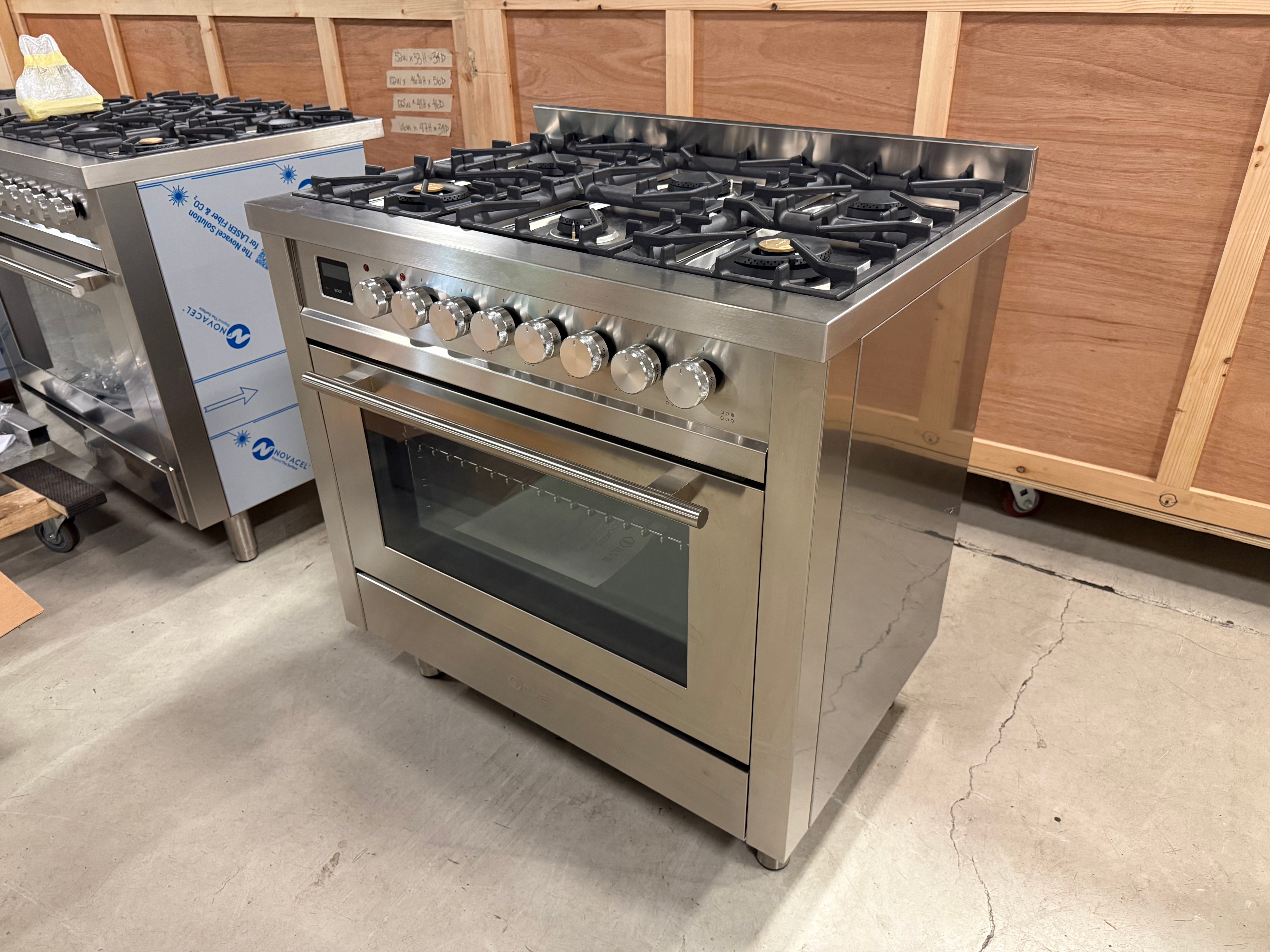 Showroom display ILVE range showing commercial aluminum knobs and triple layer glass cold door