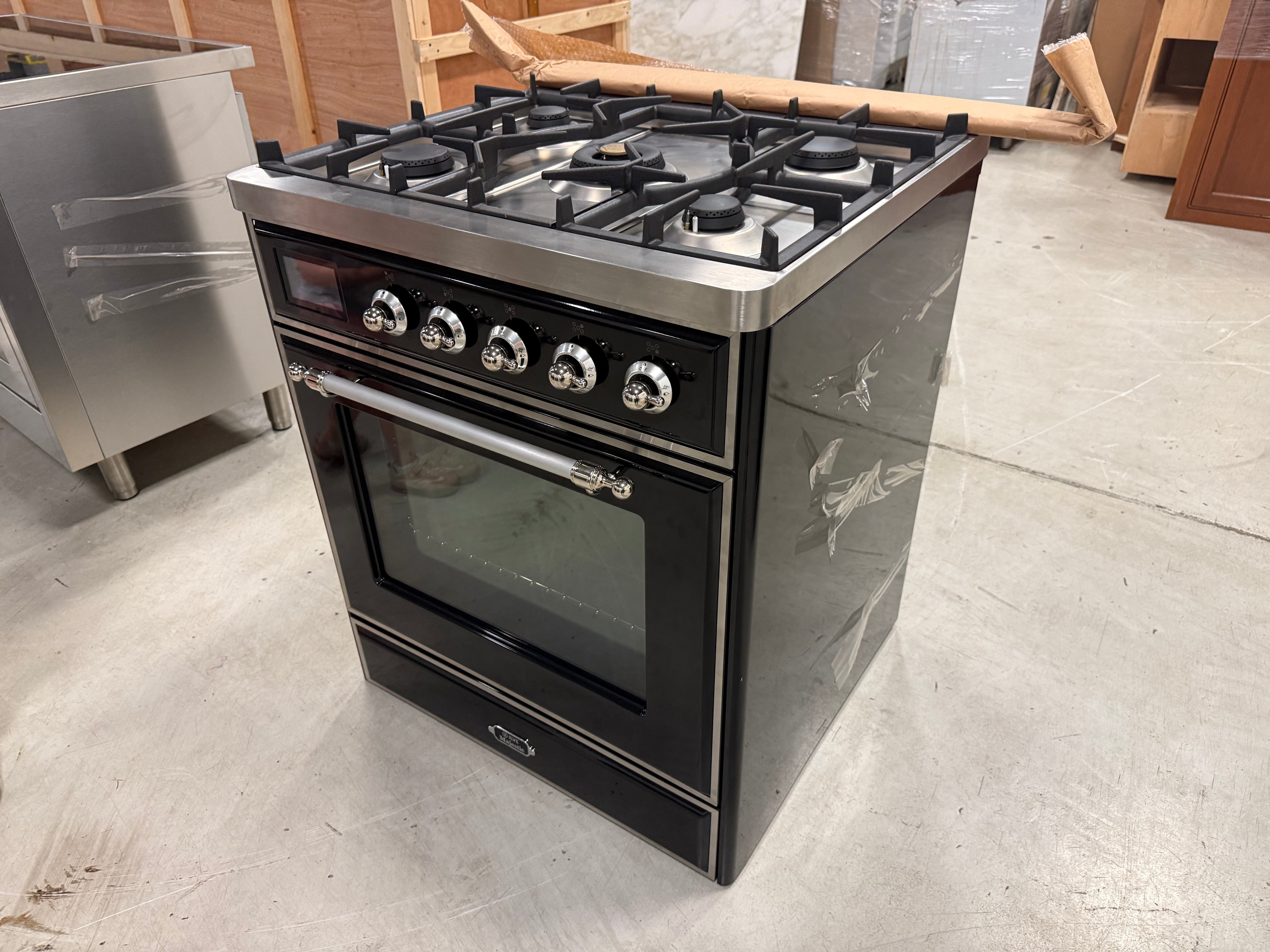 Showroom display ILVE 30 range showing 5 matte black brass burners and continuous iron grates