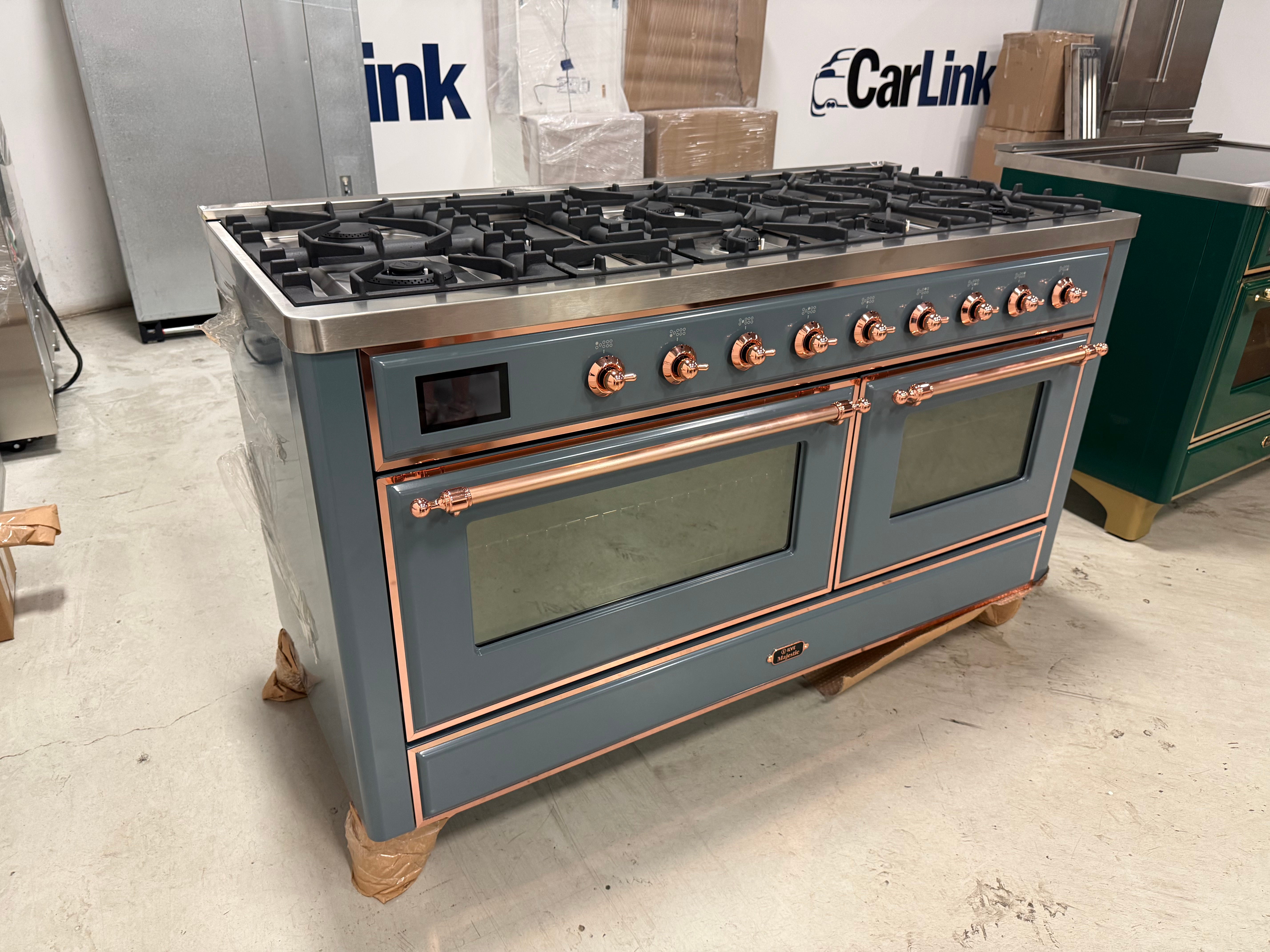Showroom display 60 inch ILVE range displaying 9 black brass burners and central griddle top