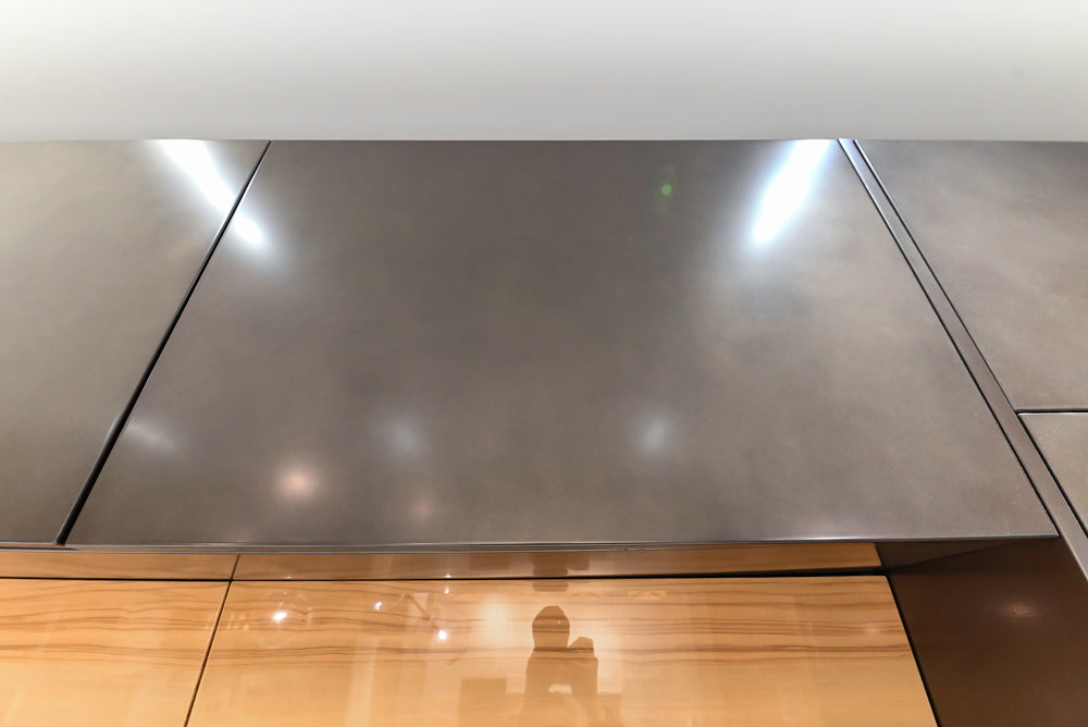 Composit Modern Brown Kitchen with Waterfall Island, Stone Countertops and Wolf & Sub-Zero Appliances