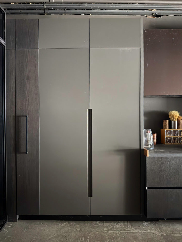Modern kitchen with dark gray cabinets and a countertop.