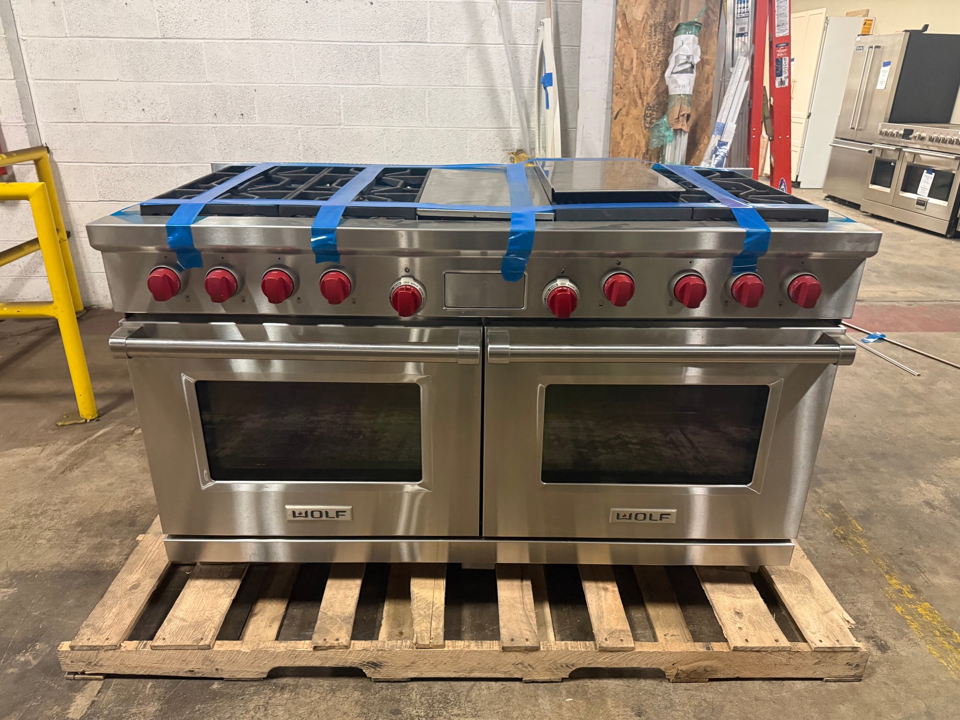 Luxury professional 60 inch dual fuel cooktop deck showing six brass burners and central infrared charcoal gas grill