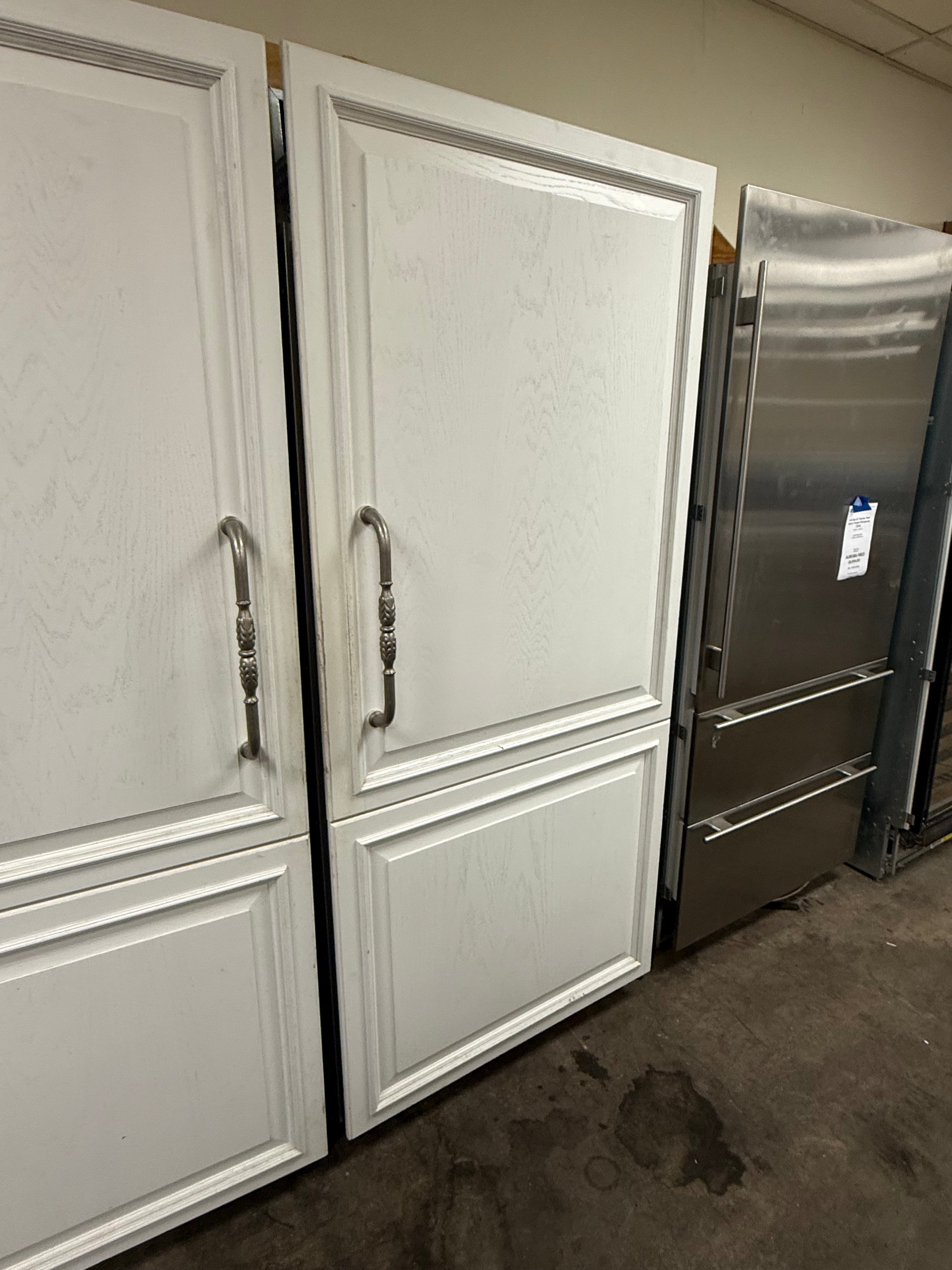 Luxury full height built in refrigerator column open showing glass shelving and fresh food crisper drawers