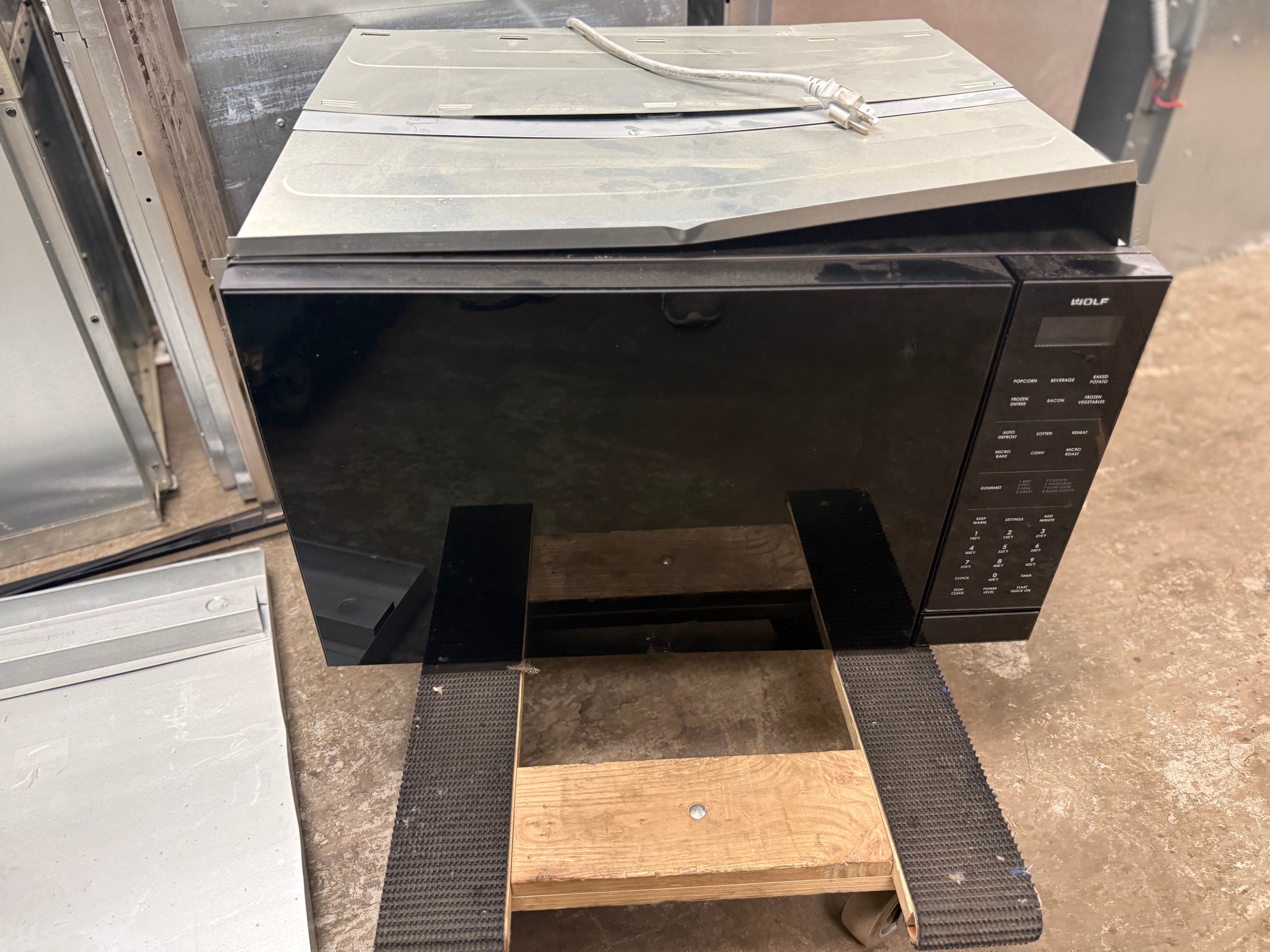 Wolf MC24 24 inch convection microwave oven front view sleek black glass face
