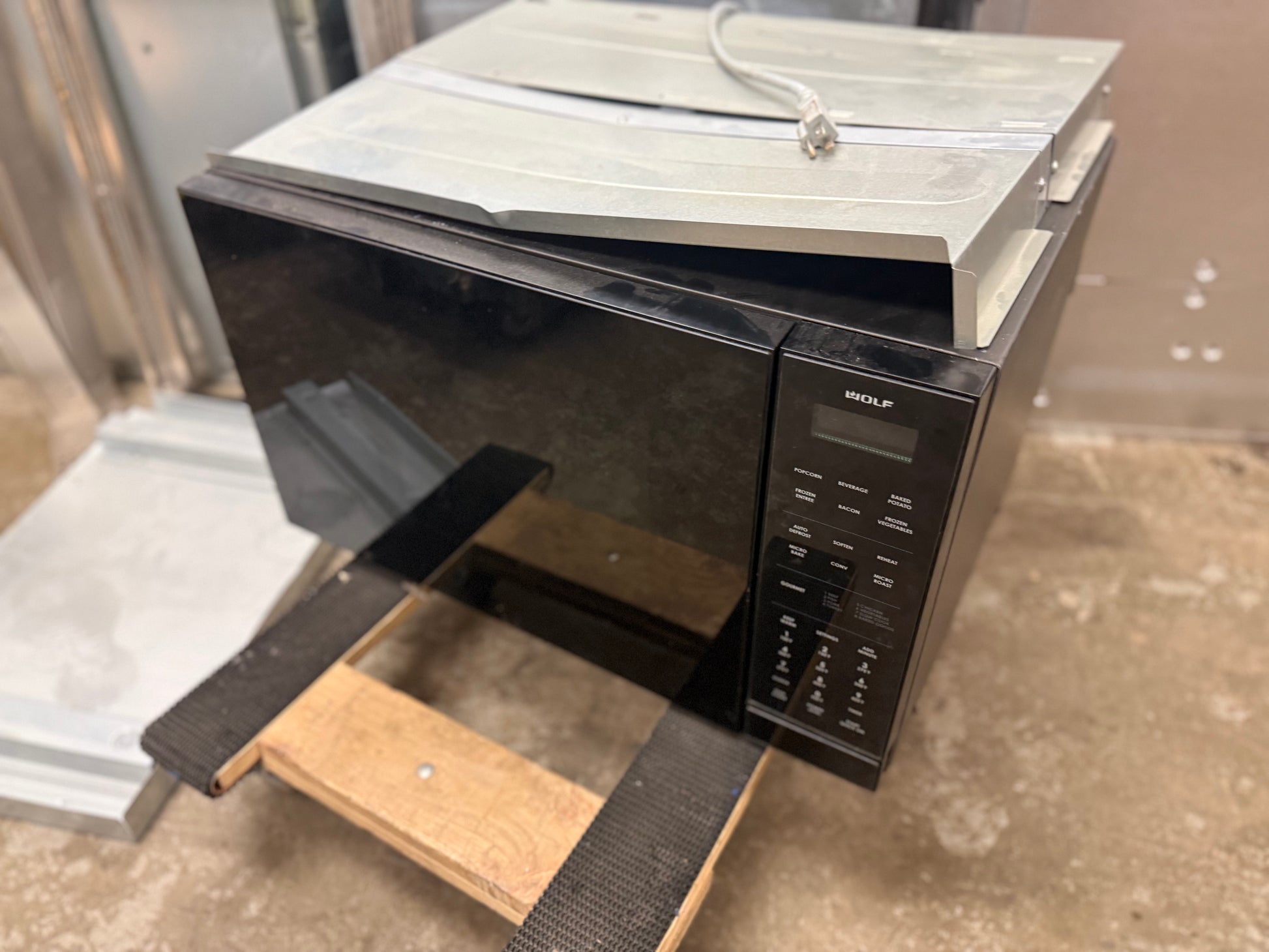 Luxury 1.5 cubic foot convection microwave open showing premium stainless steel interior and wire baking rack