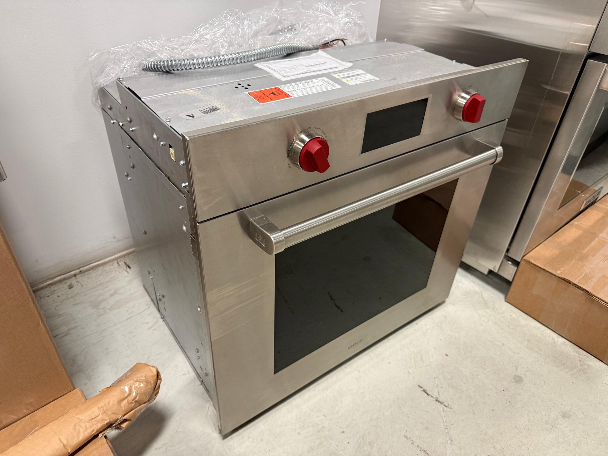 showroom display Wolf M series oven showcasing cobalt blue porcelain interior and wire racks