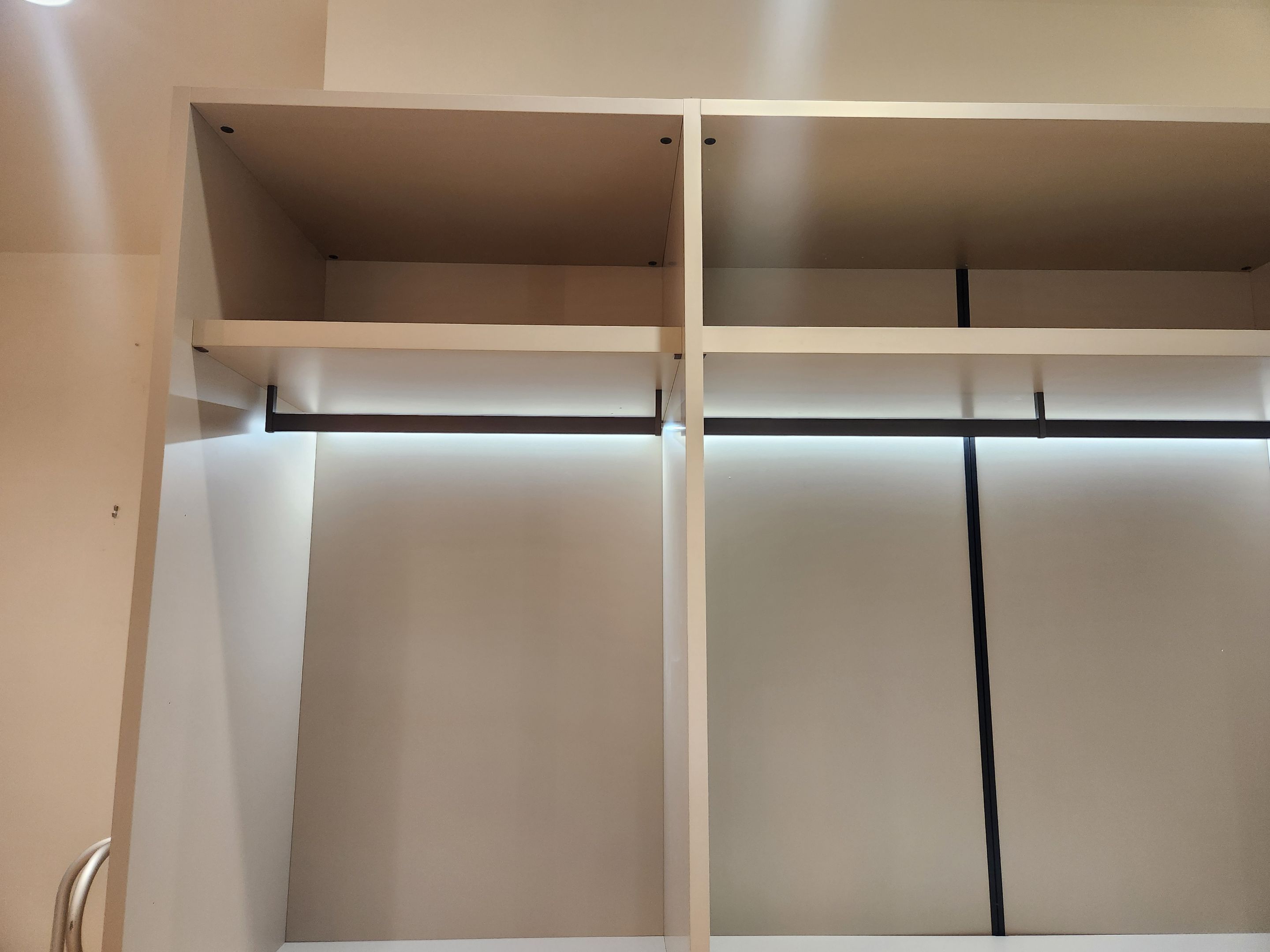 European minimalist wardrobe dressing room with custom shelving and accessory drawers