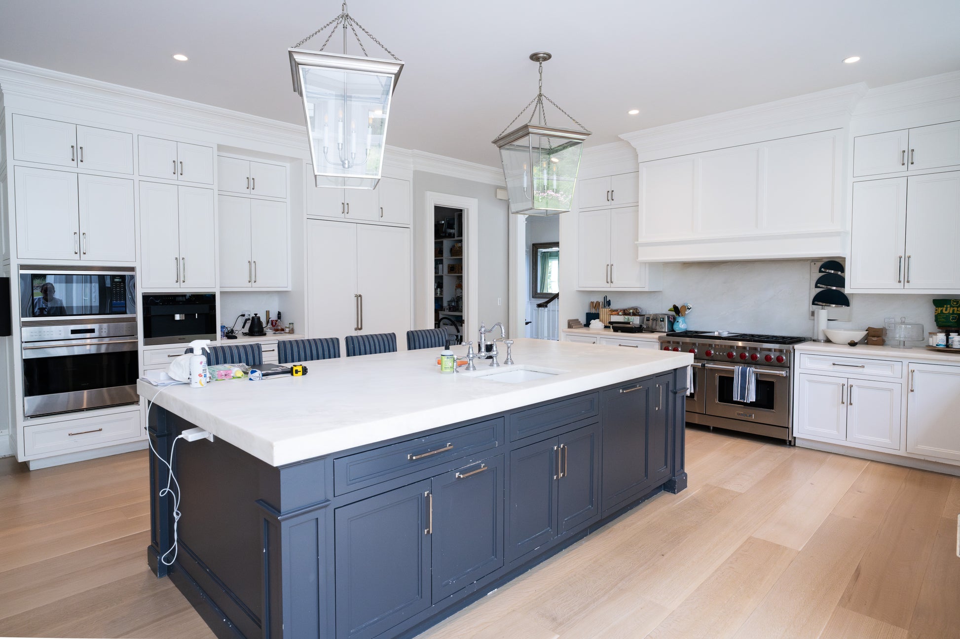 The Abercorn transitional white kitchen cabinetry with large center island and professional 48 inch Wolf range