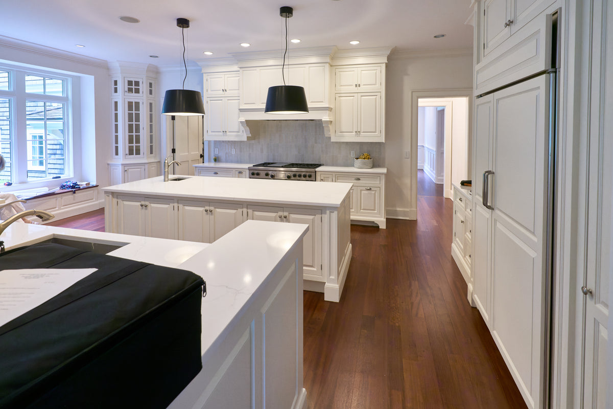 The Sovereign transitional white kitchen with double island and Wolf 48 inch range