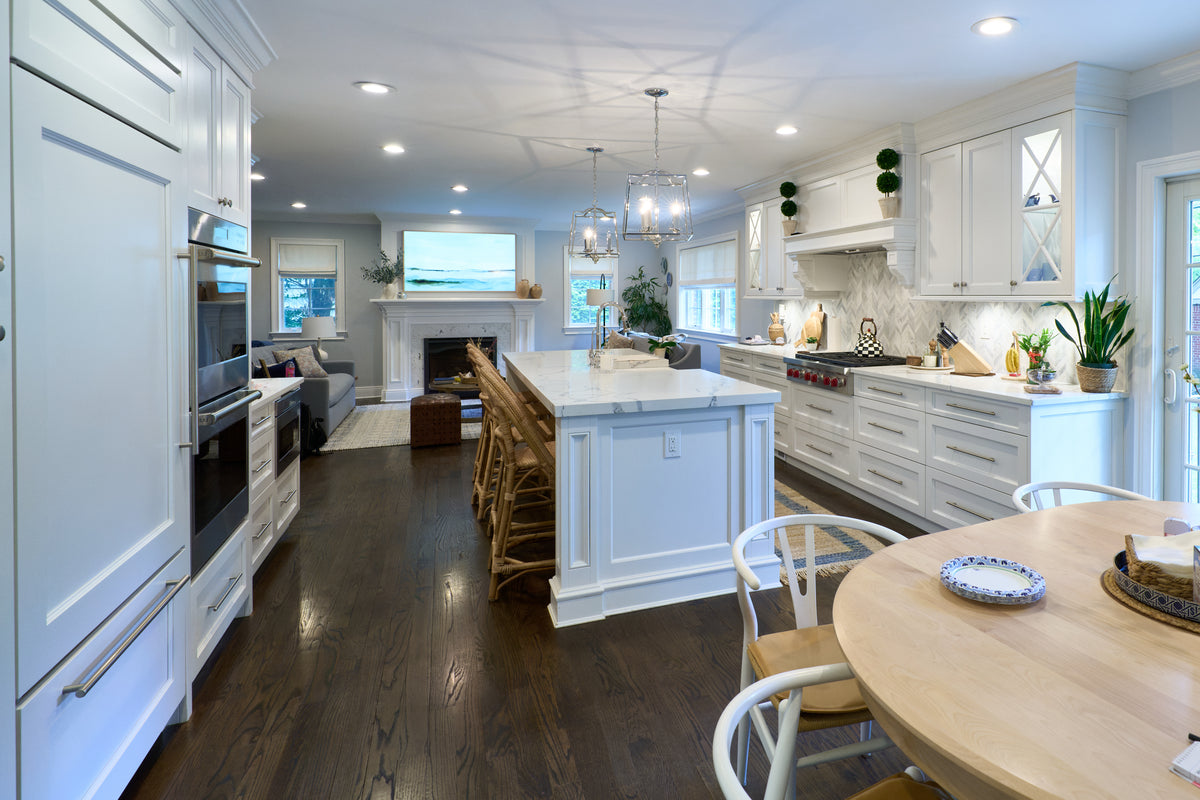 High-end architectural white kitchen suite with decorative millwork and professional range