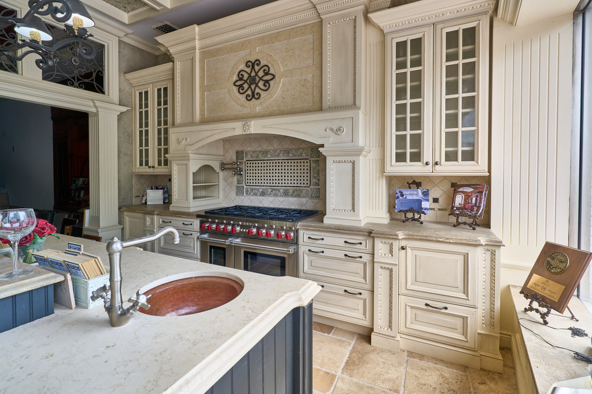 High-end architectural cream kitchen suite with decorative millwork and island bas
