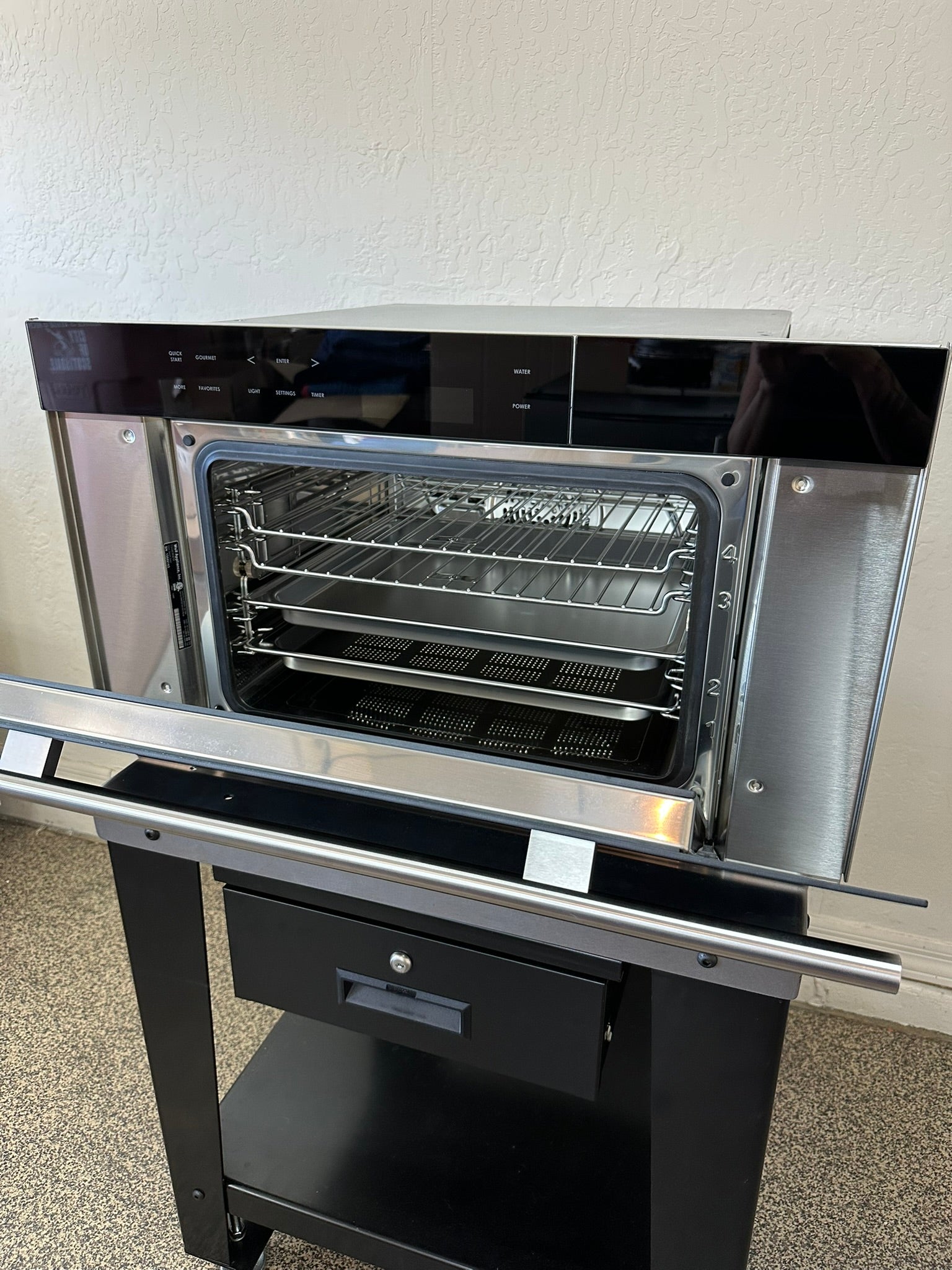 Pristine stainless steel interior of Wolf convection steam oven.