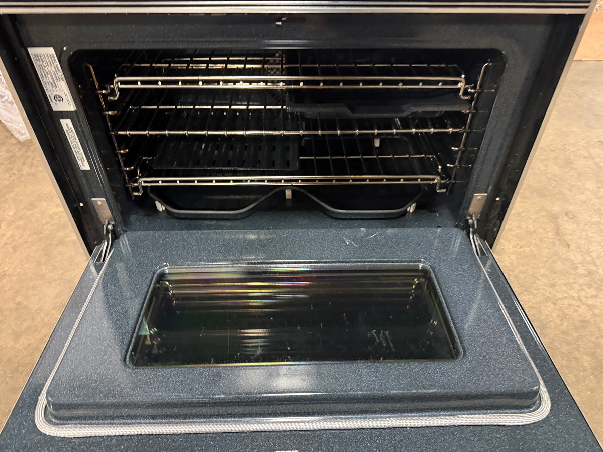 An open built-in oven showing the interior racks, glass door window, and dark interior cavity.
