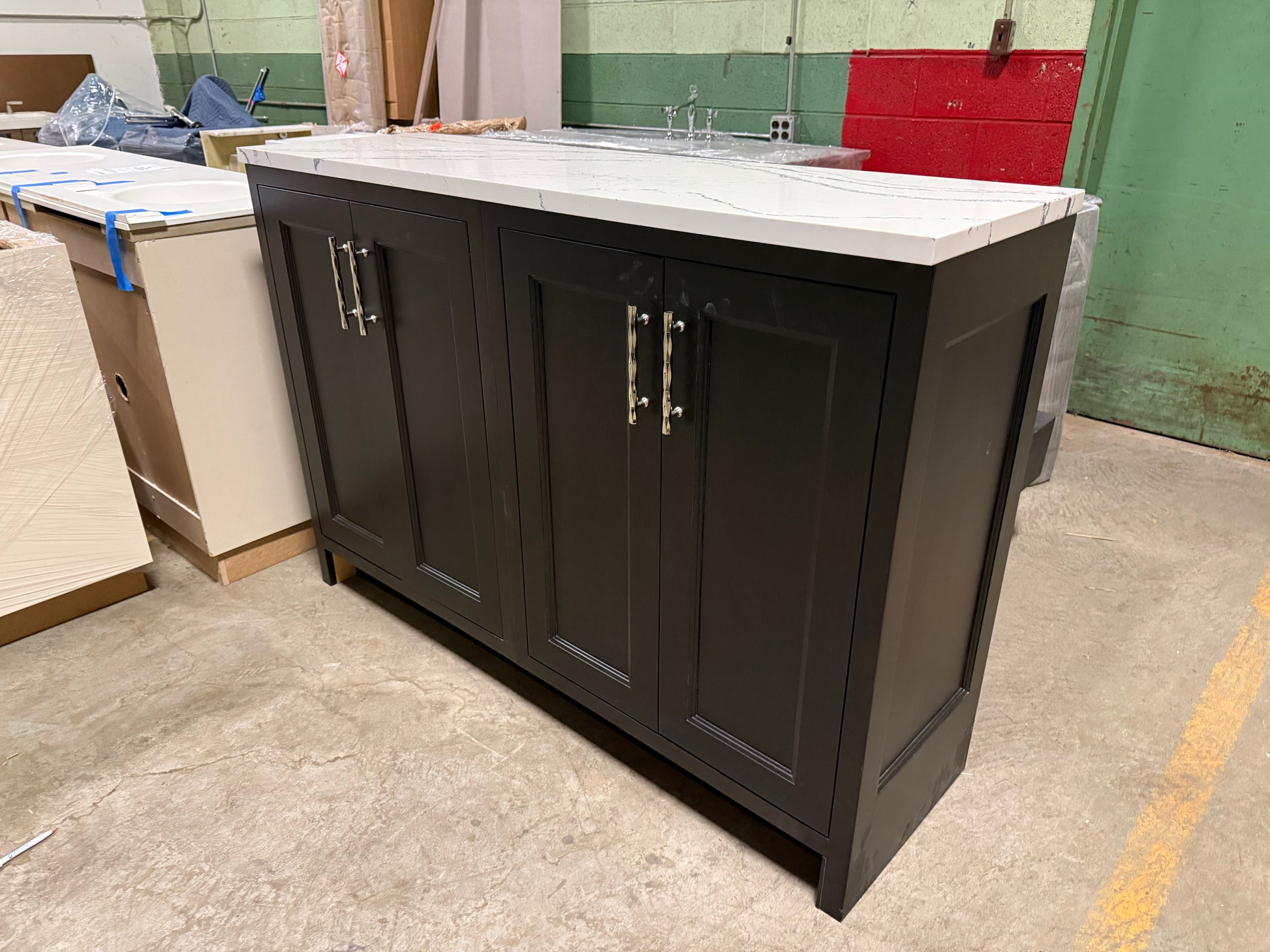 Dark wooden kitchen island with white countertop in a warehouse setting