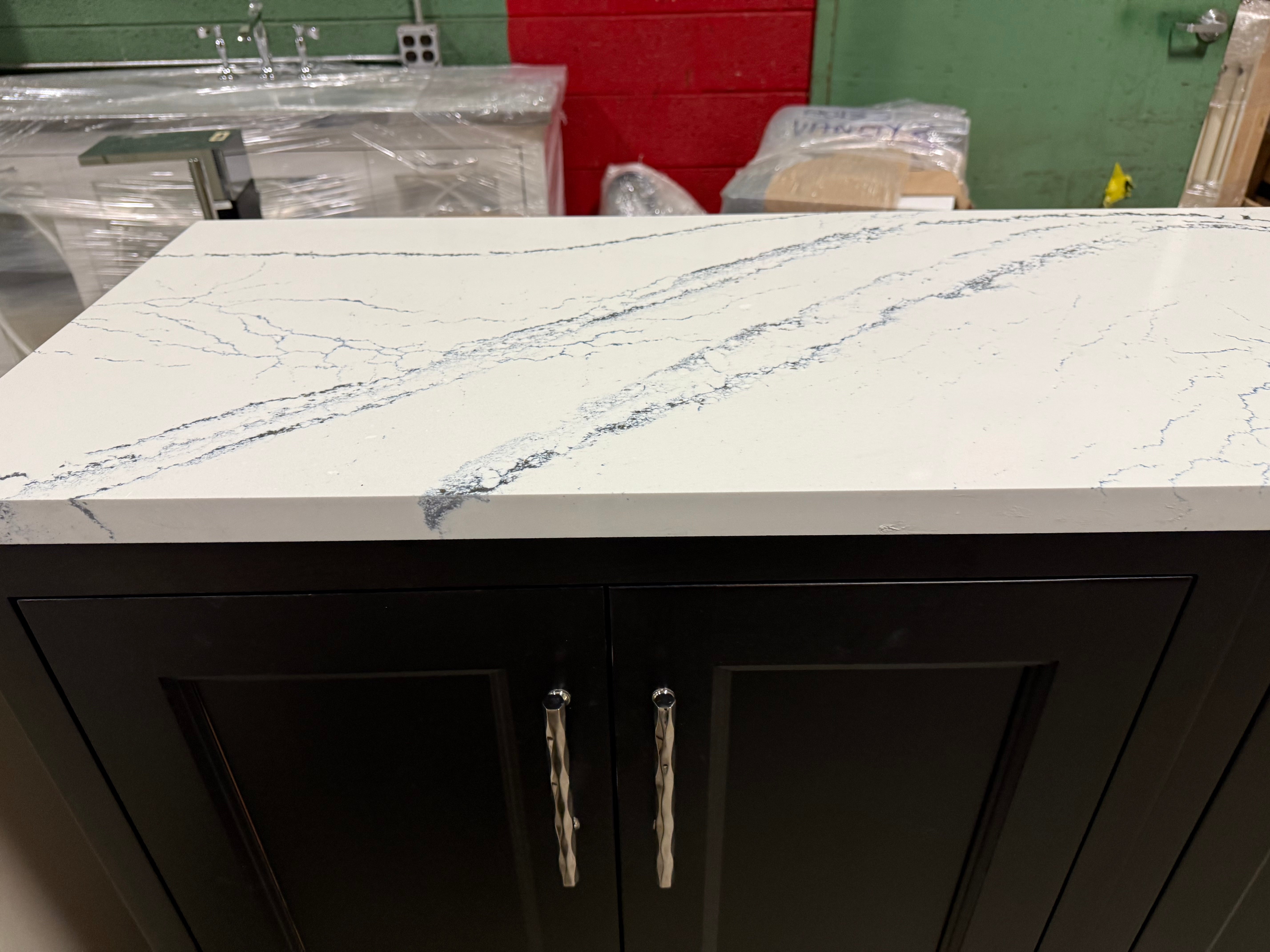 Kitchen counter with marble-like countertop and black cabinets