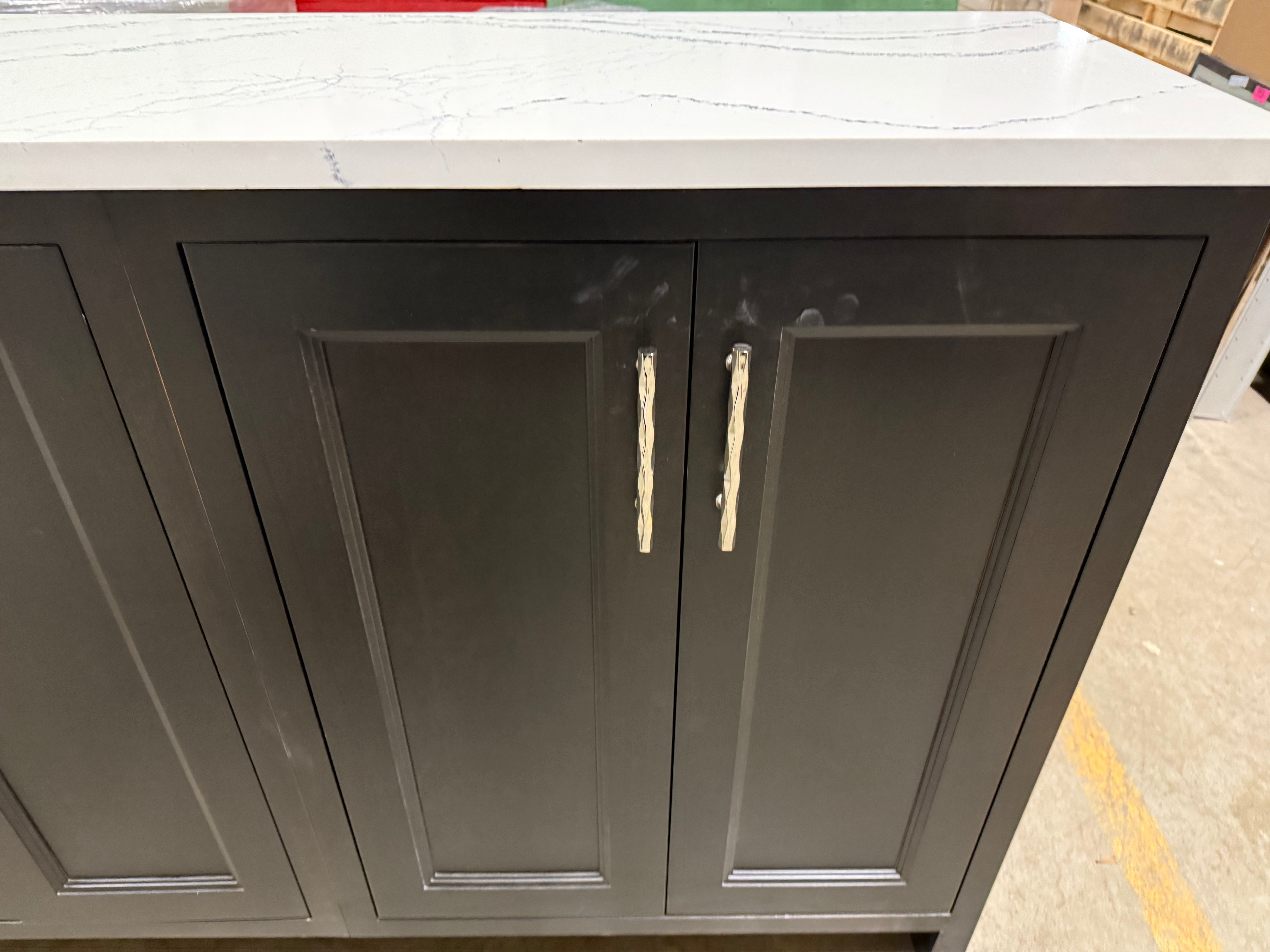 kitchen cabinet with marble countertop on a concrete floor
