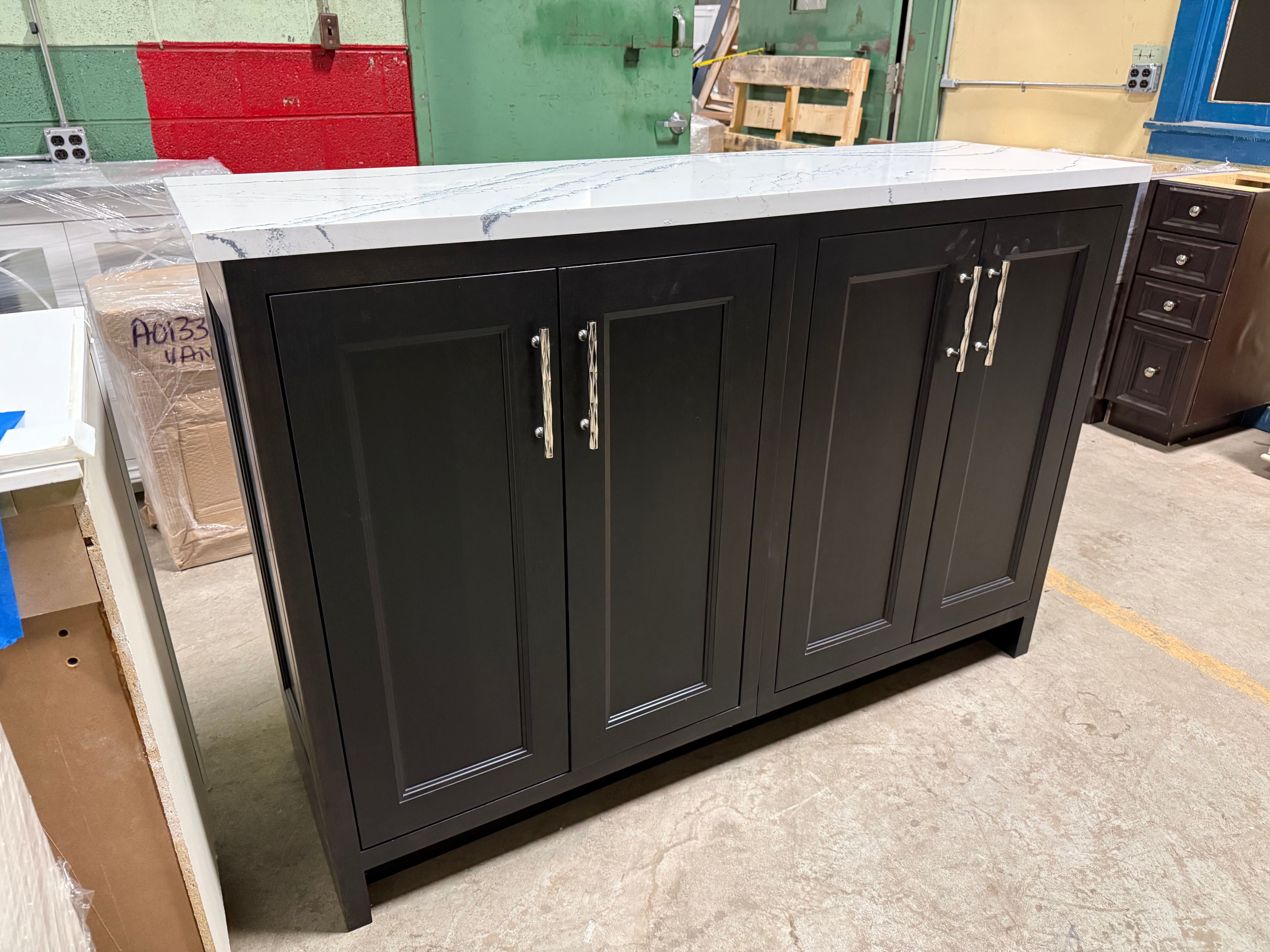 Dark wood kitchen island with marble countertop in a warehouse setting