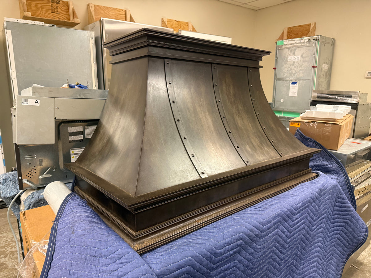 Luxury architectural bespoke metal range hood with industrial patina finish